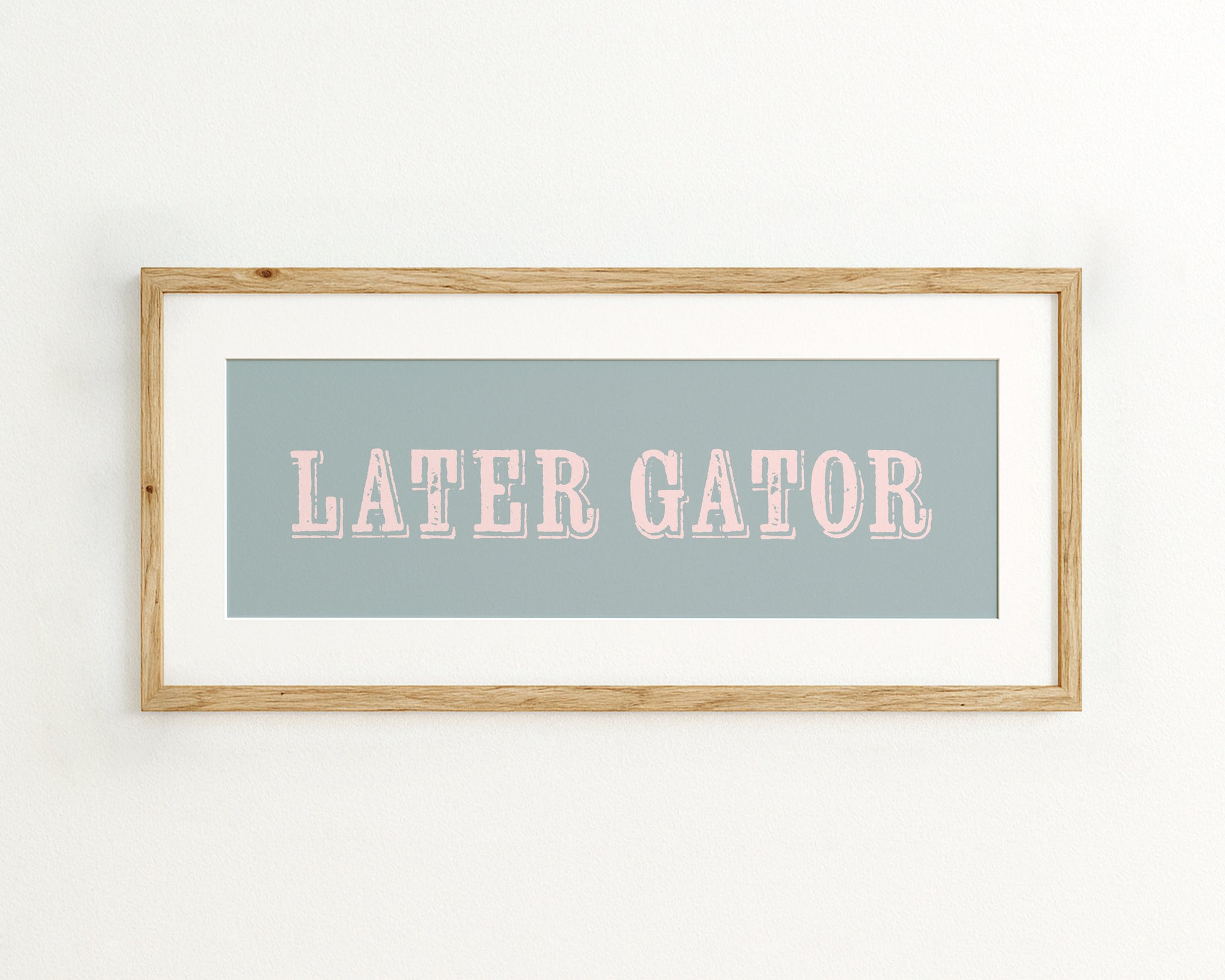 Framed print with 'LATER GATOR' text on a light blue background