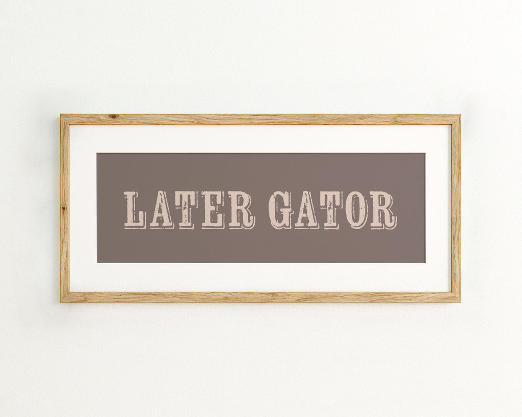 Framed print with 'LATER GATOR' text on a brown background