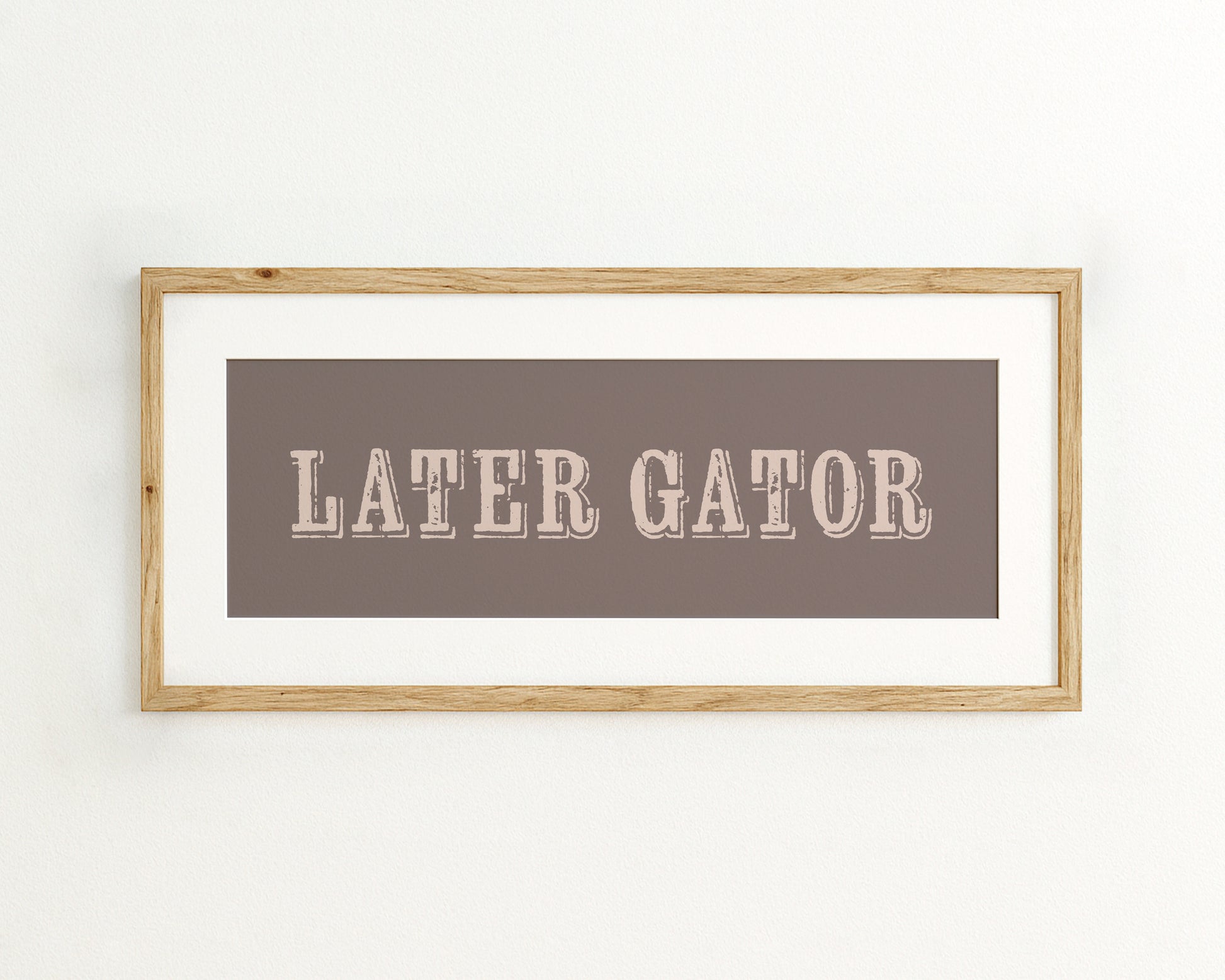 Framed print with 'LATER GATOR' text on a brown background