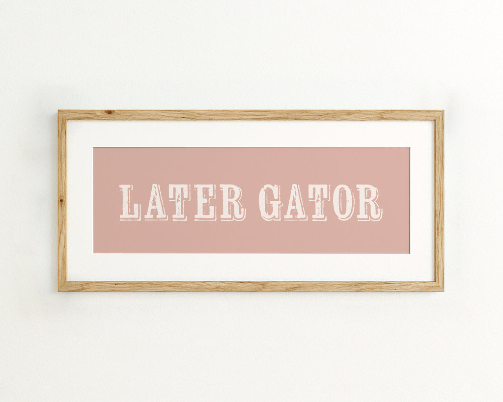 Framed print with 'LATER GATOR' text on a pink background