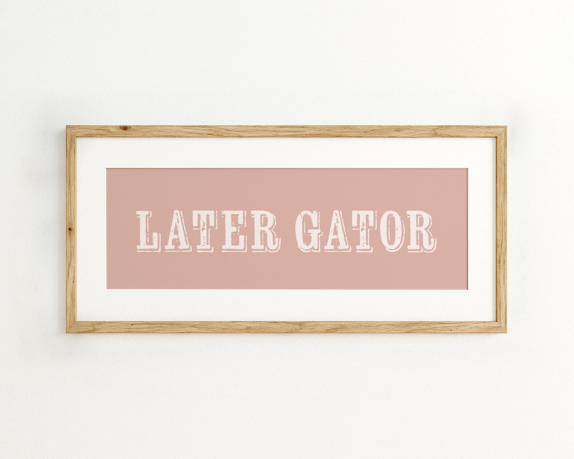 Framed print with 'LATER GATOR' text on a pink background