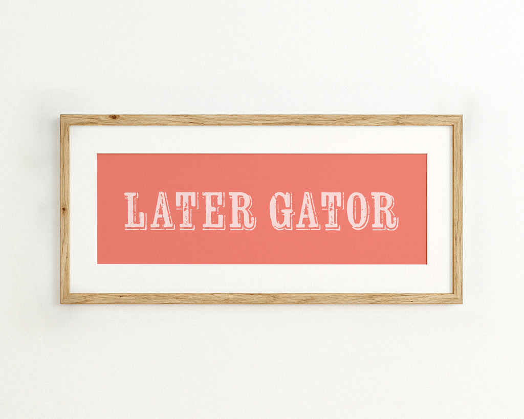 Framed print with 'LATER GATOR' text on a coral background