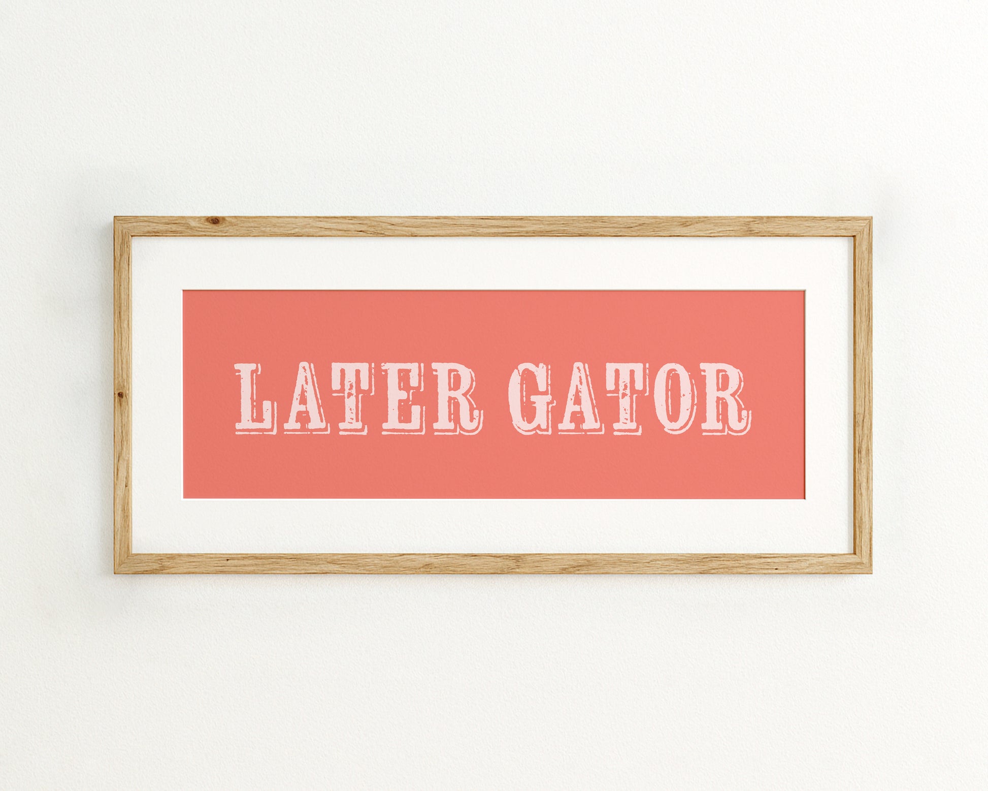 Framed print with 'LATER GATOR' text on a coral background