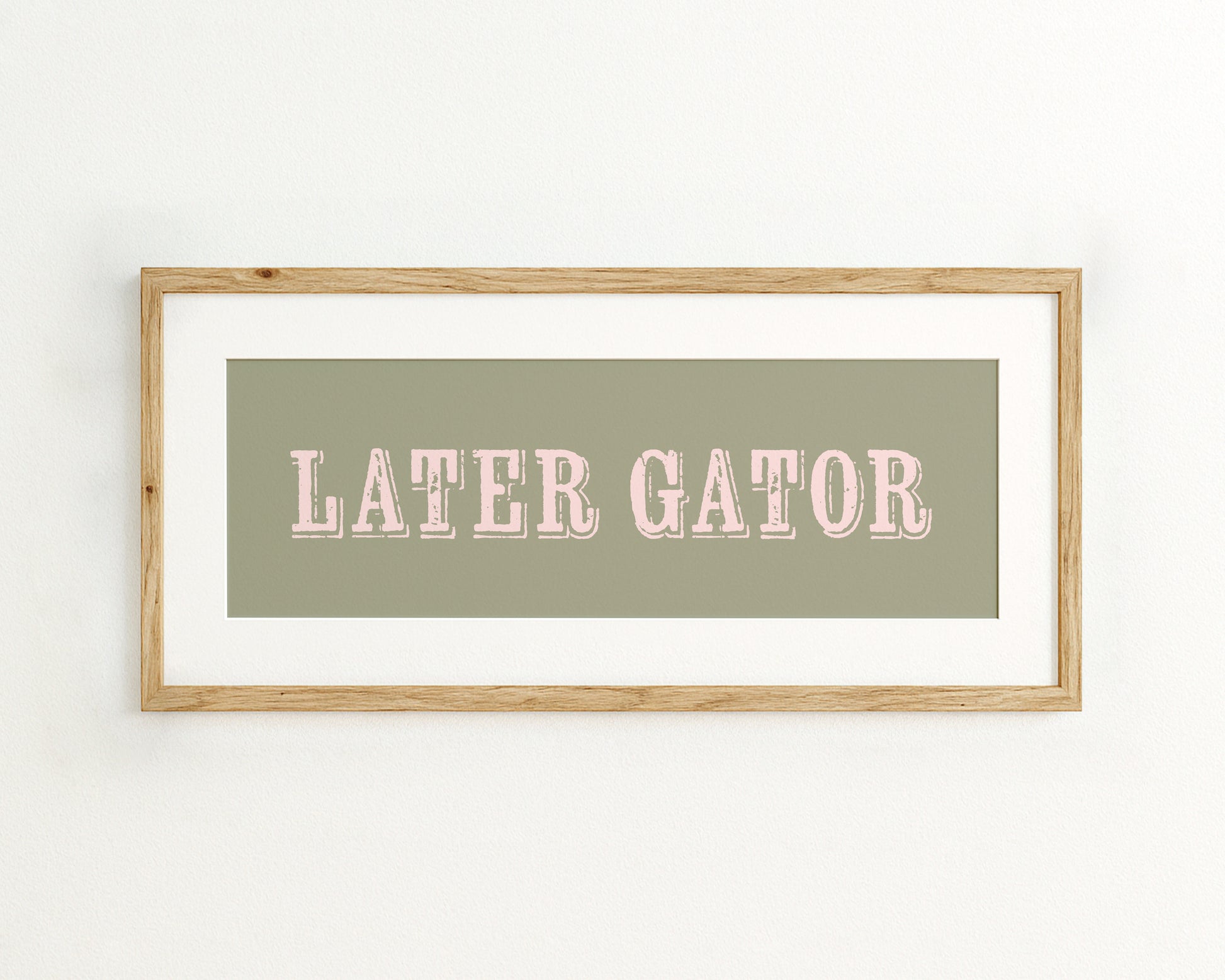 Framed print with 'LATER GATOR' text on a light green background