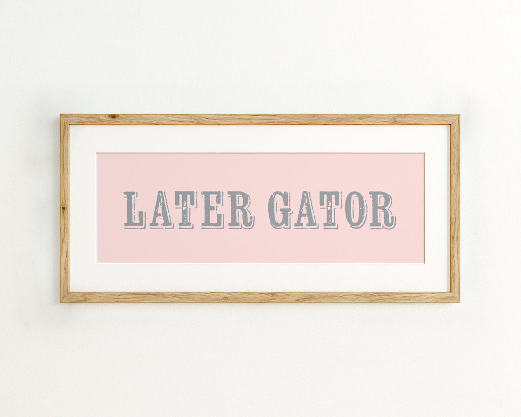 Framed print with 'LATER GATOR' text on a pink background