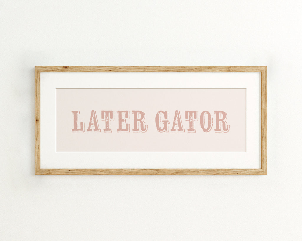 Framed print with 'LATER GATOR' text on a light pink background