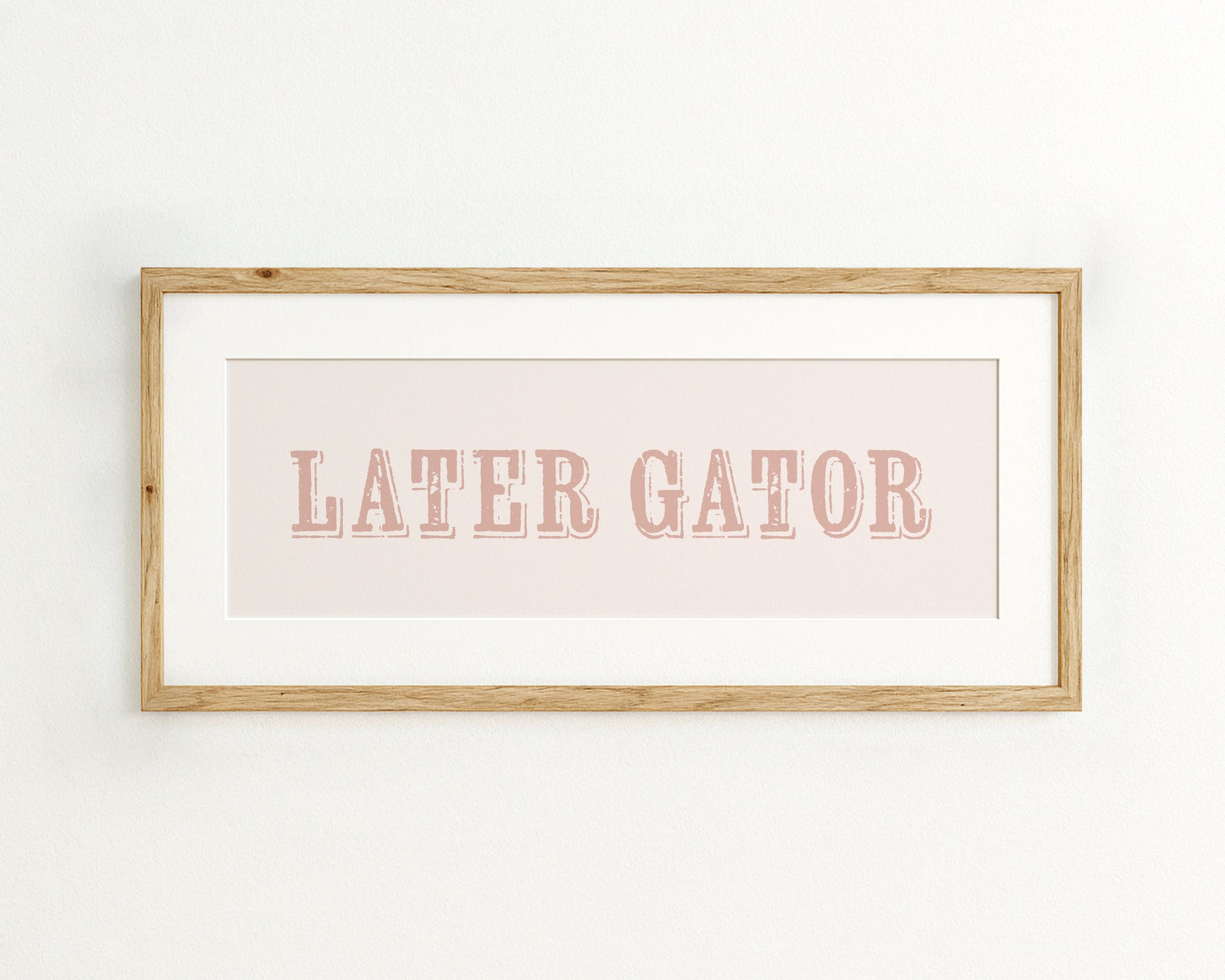 Framed print with 'LATER GATOR' text on a light pink background