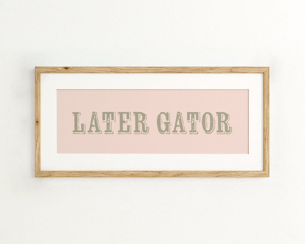 Framed print with 'LATER GATOR' text on a pink background