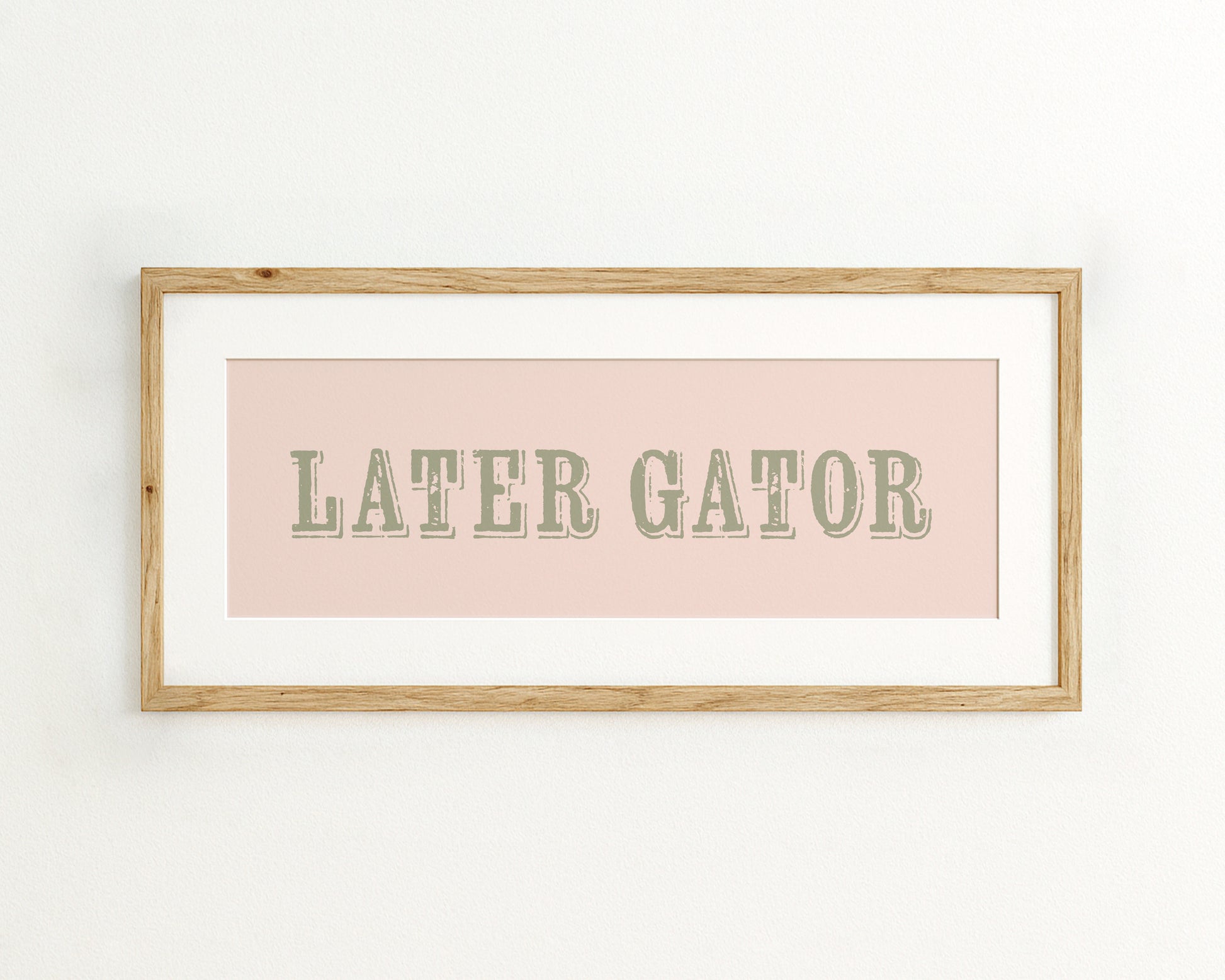 Framed print with 'LATER GATOR' text on a pink background