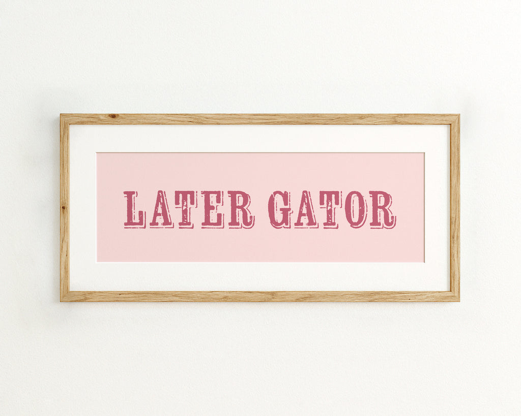 Framed print with 'LATER GATOR' text on a pink background
