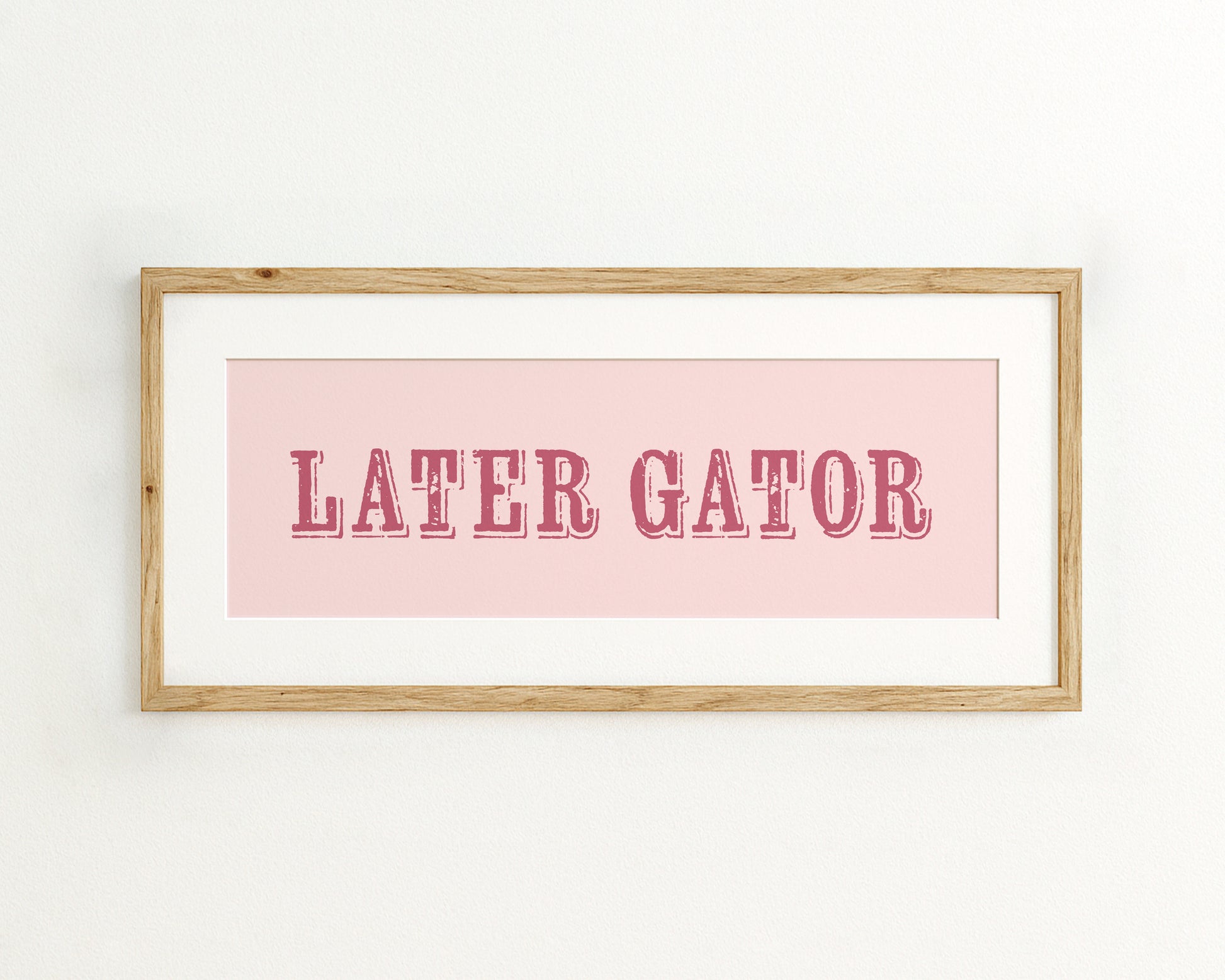 Framed print with 'LATER GATOR' text on a pink background