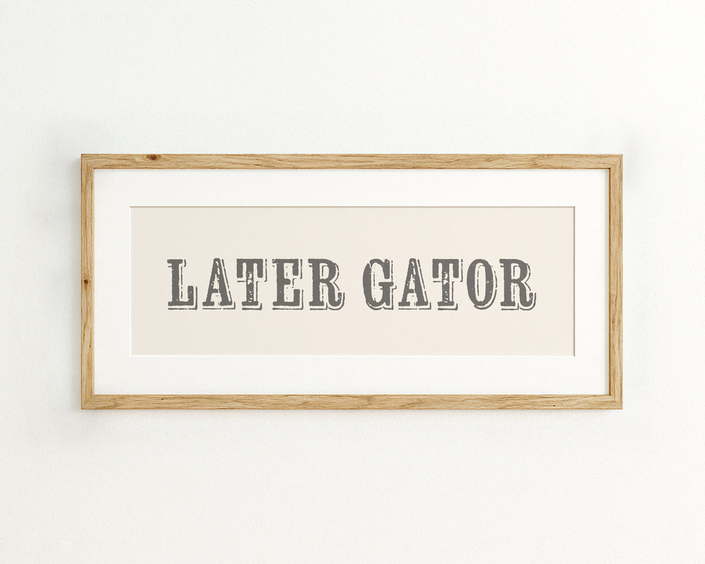 Framed print with 'LATER GATOR' text on a cream background