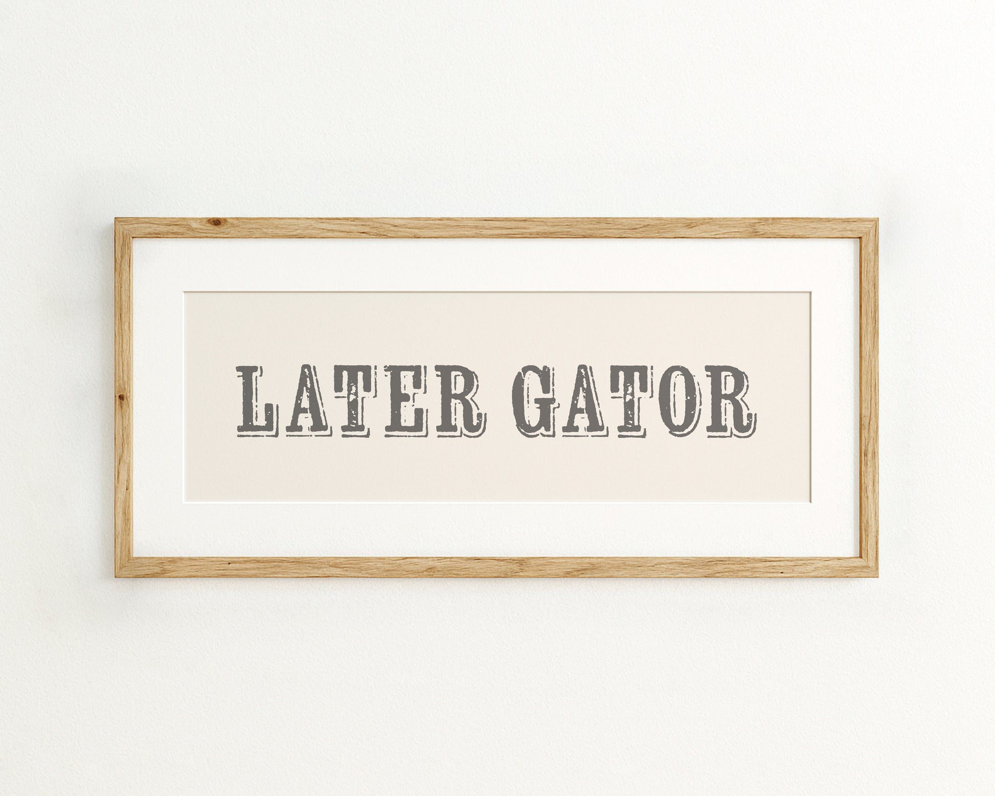Framed print with 'LATER GATOR' text on a cream background
