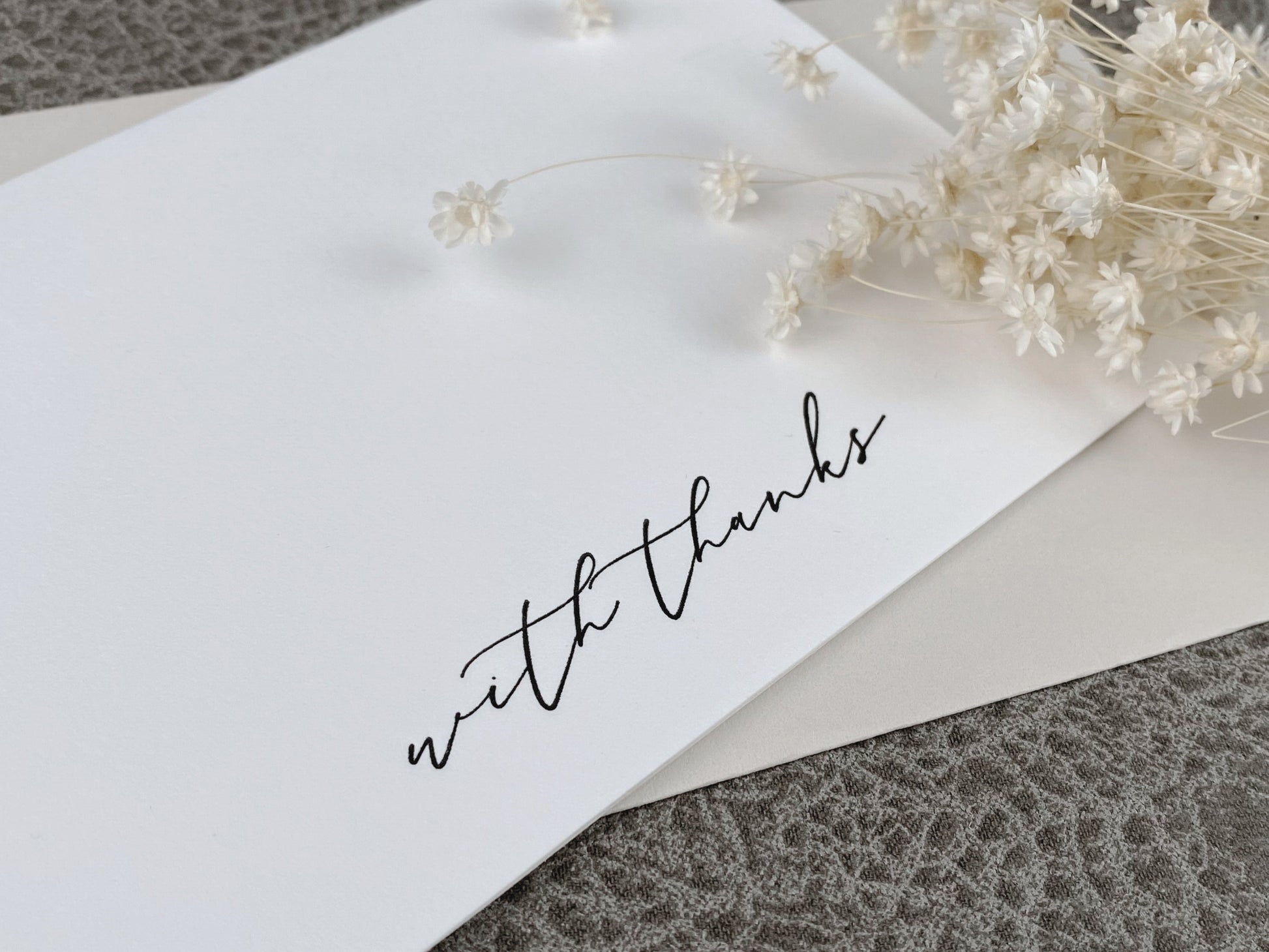 White greeting card featuring 'with thanks printed in letterpress style