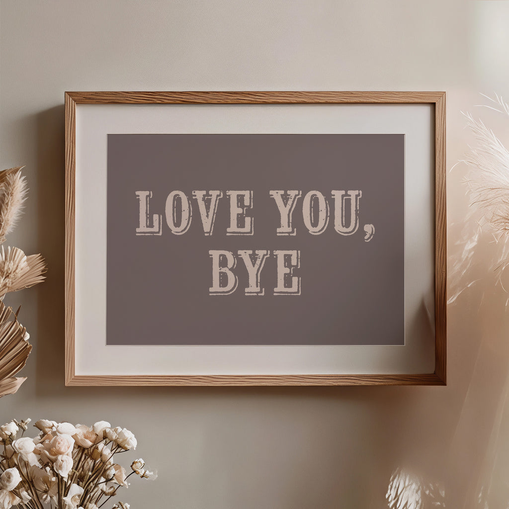 Framed artwork with 'LOVE YOU, BYE' text on a neutral wall.