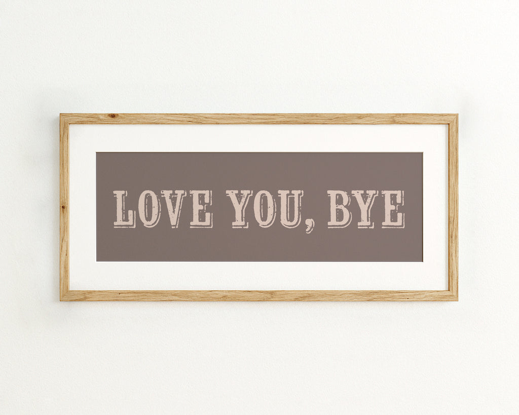 Framed artwork with 'LOVE YOU, BYE' text on a plain background