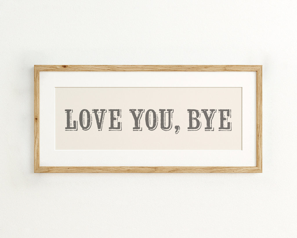 Framed artwork with 'LOVE YOU, BYE' text on a cream background