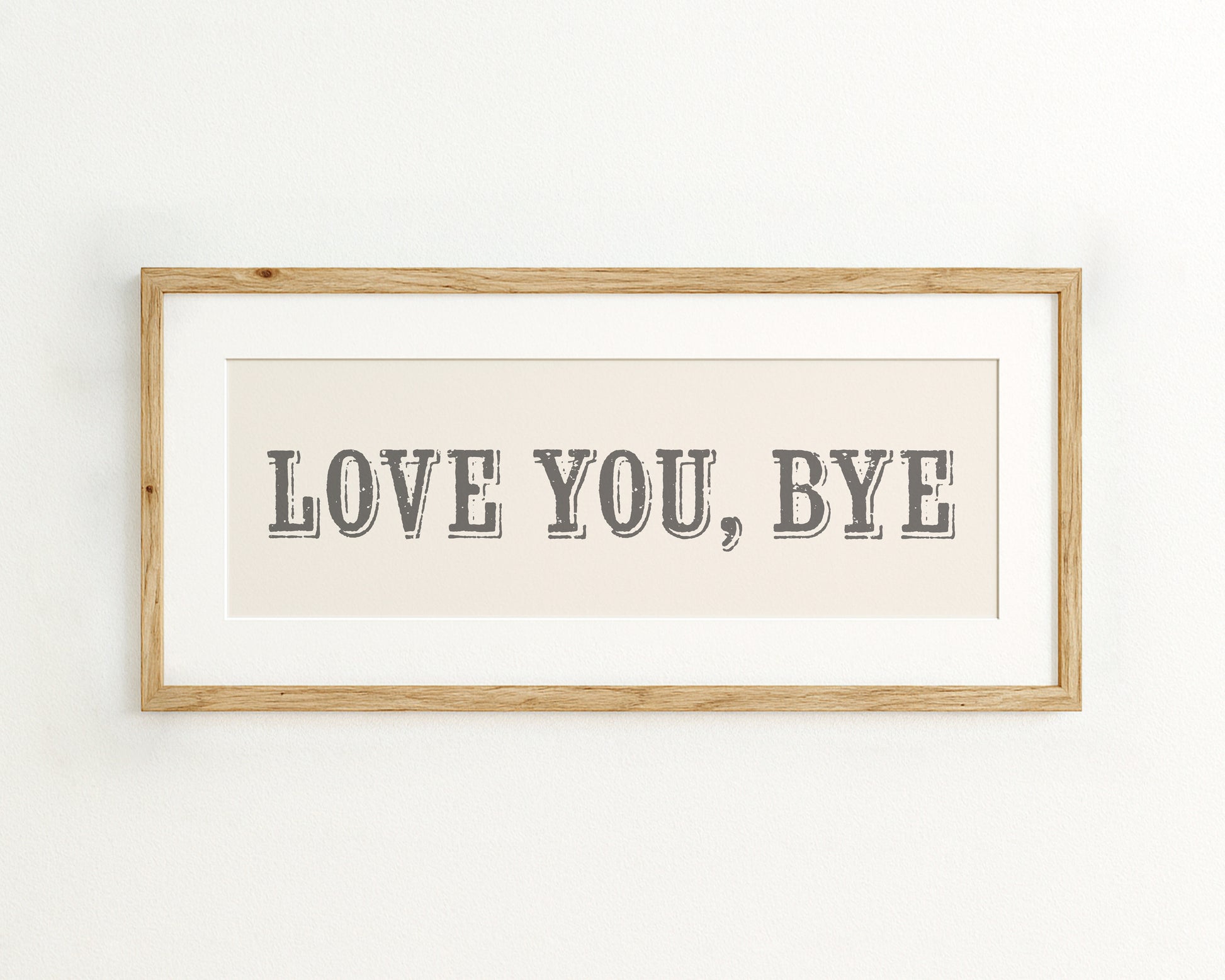 Framed artwork with 'LOVE YOU, BYE' text on a cream background