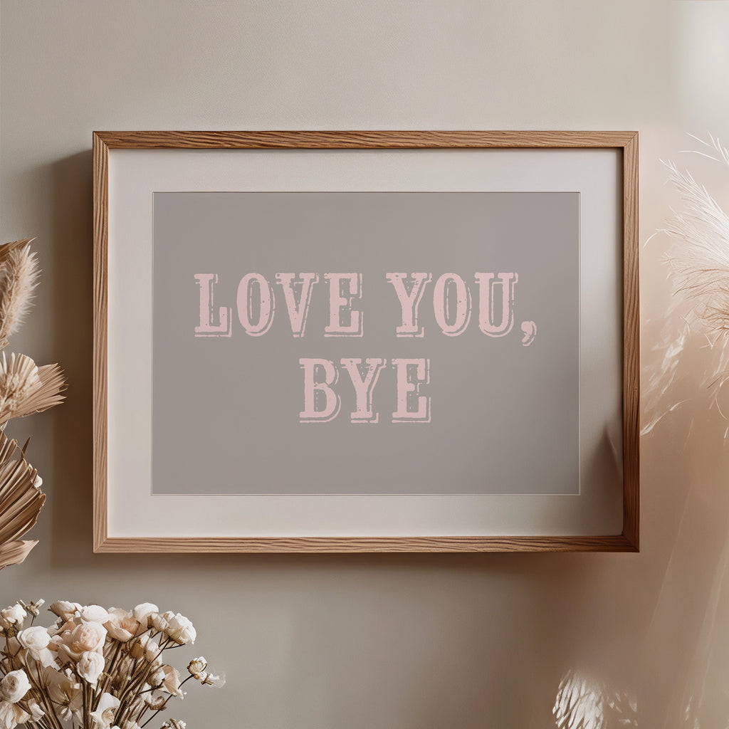 Framed artwork with 'LOVE YOU, BYE' text on a neutral wall.