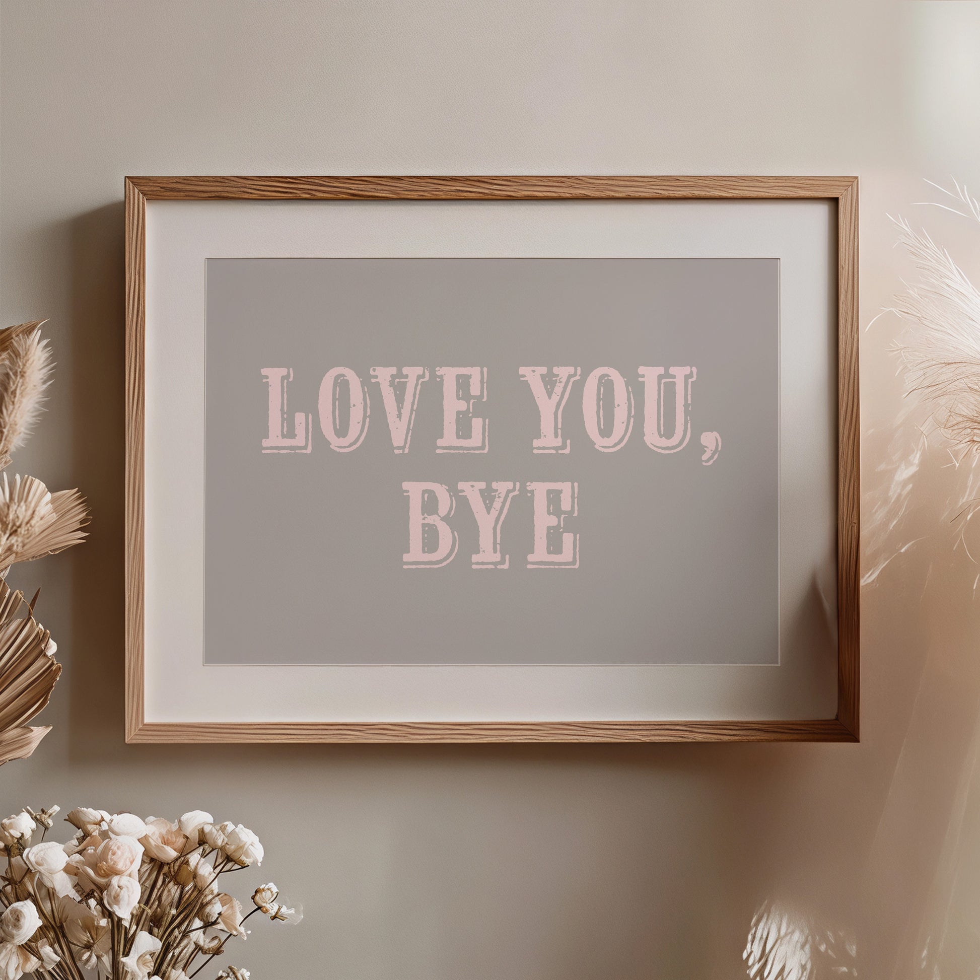 Framed artwork with 'LOVE YOU, BYE' text on a neutral wall.