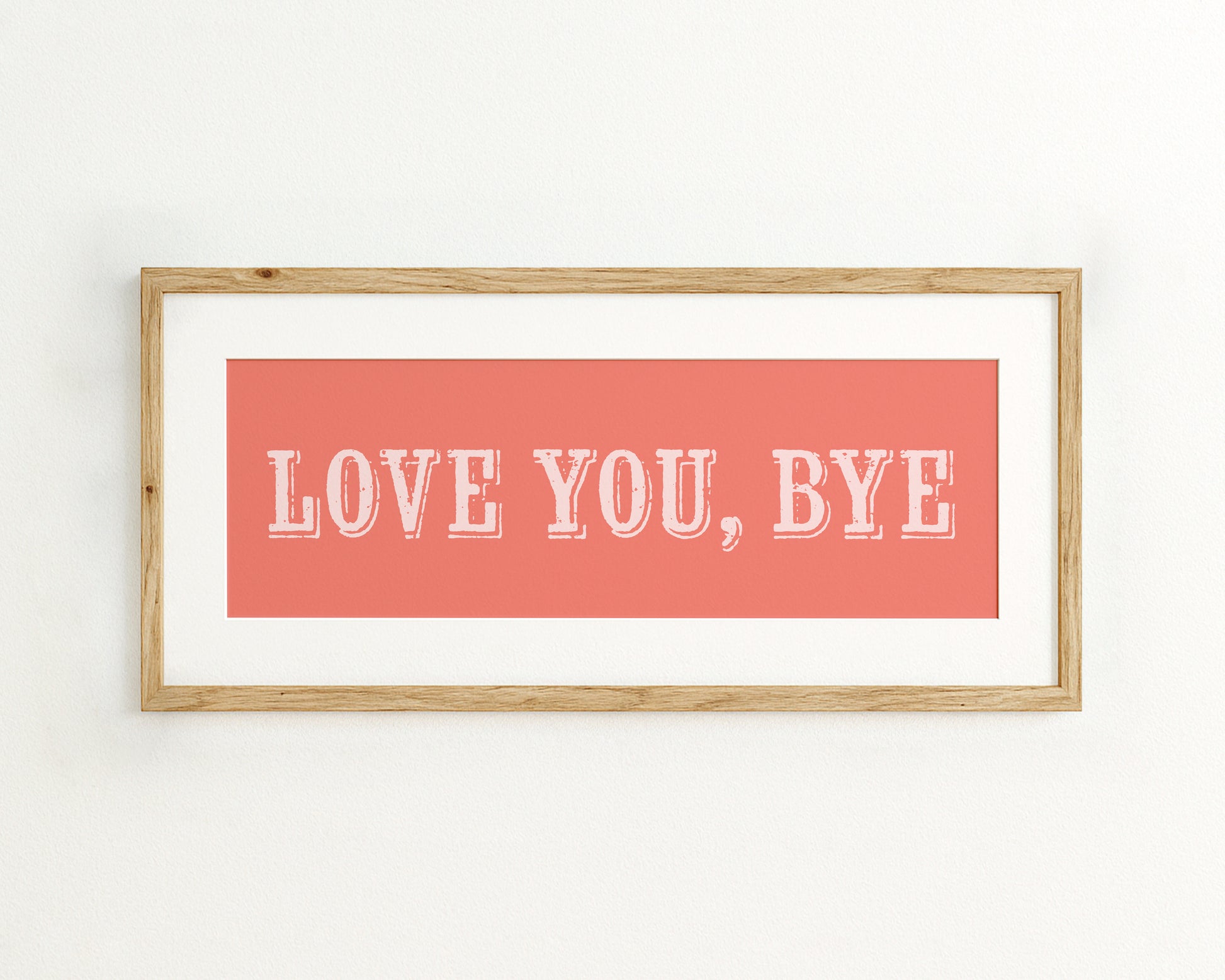 Framed artwork with 'LOVE YOU, BYE' text on a coral pink background