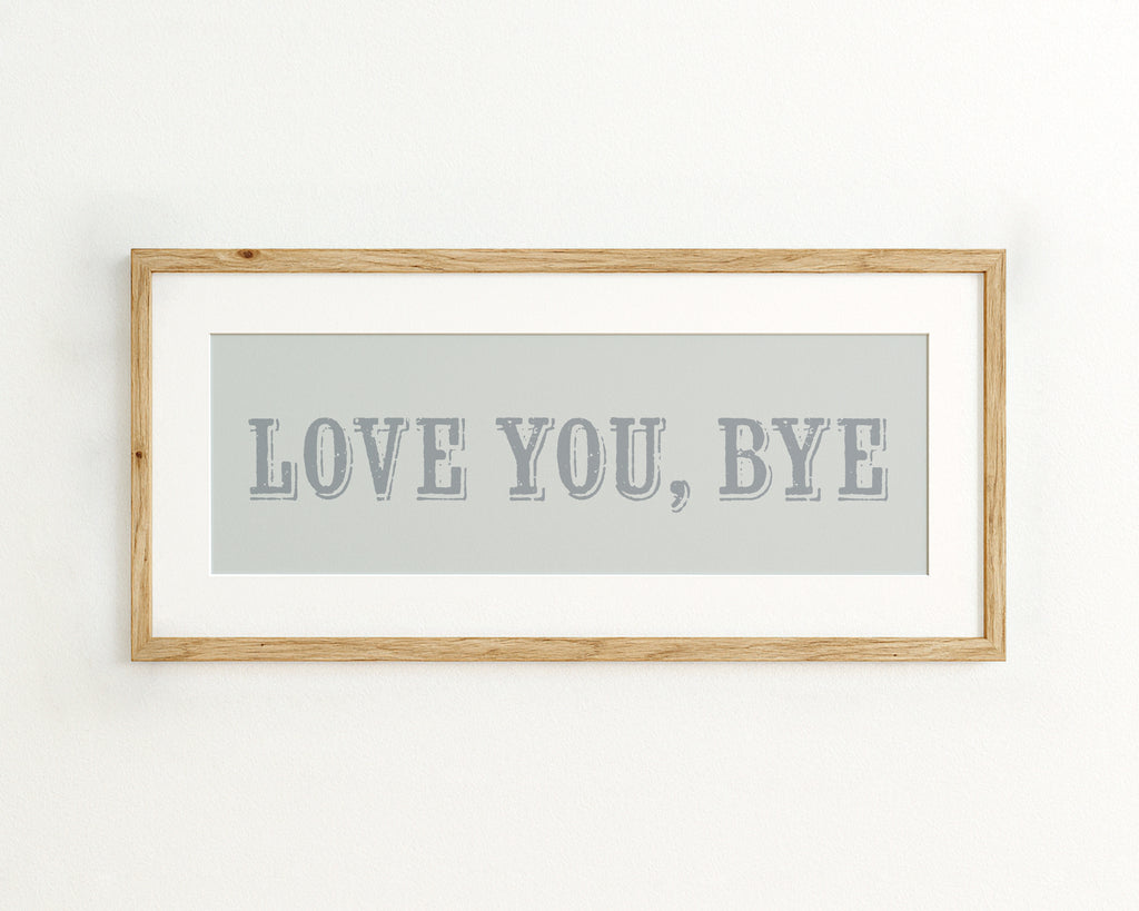 Framed artwork with 'LOVE YOU, BYE' text on a light blue background