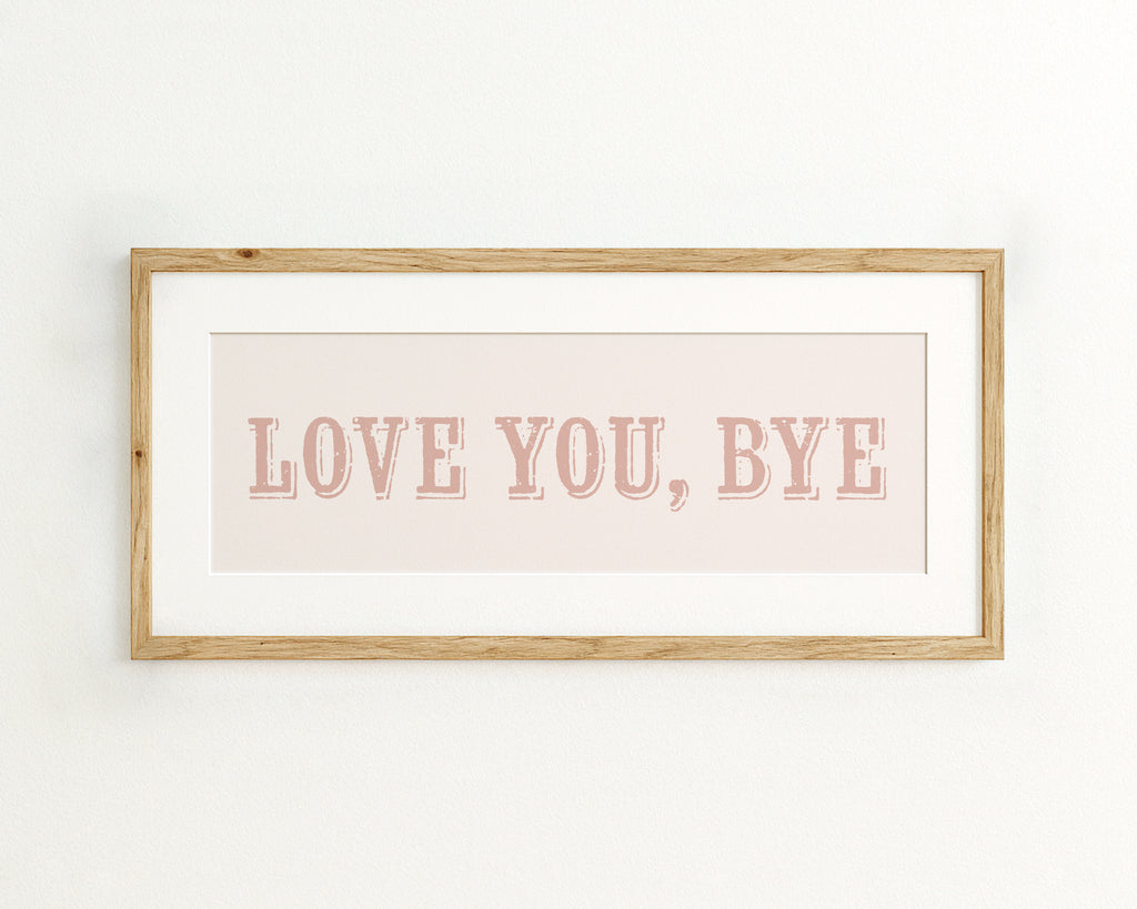 Framed artwork with 'LOVE YOU, BYE' text on a light background
