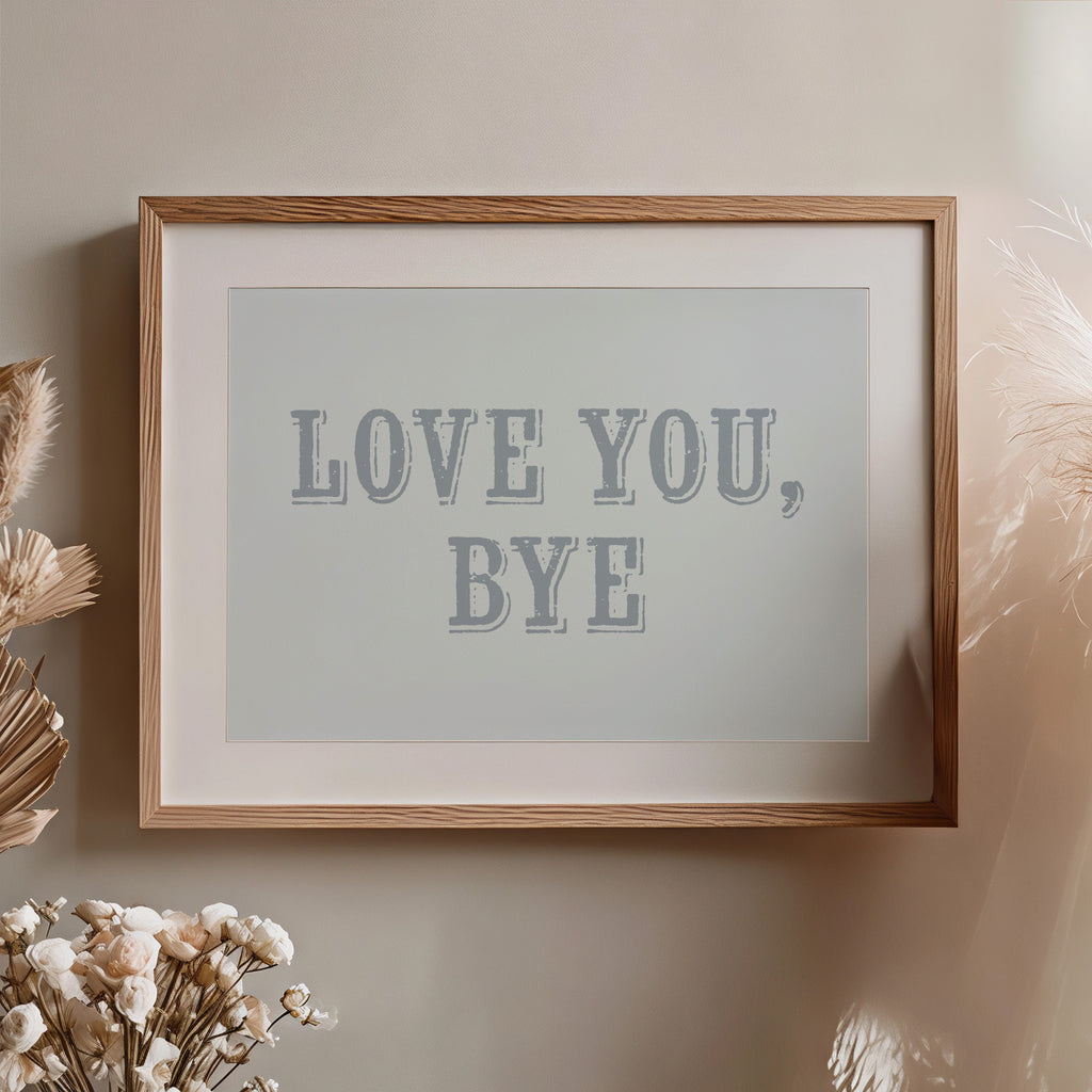 Framed artwork with 'LOVE YOU, BYE' text on a neutral wall.