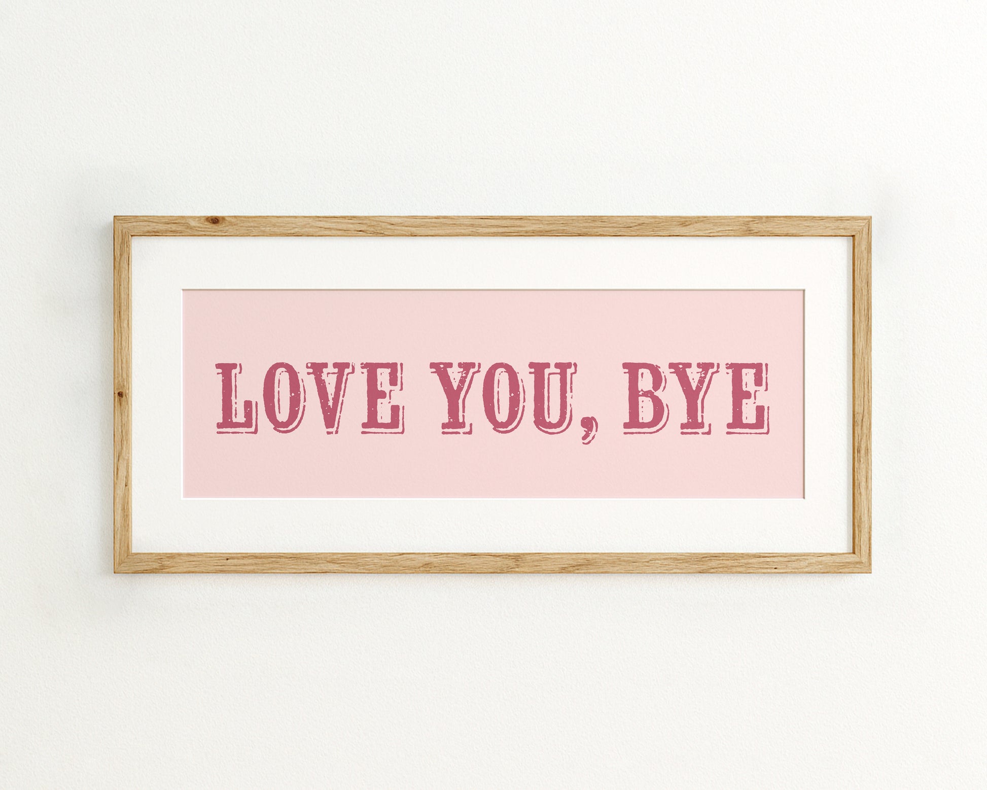 Framed artwork with 'LOVE YOU, BYE' text on a pink background