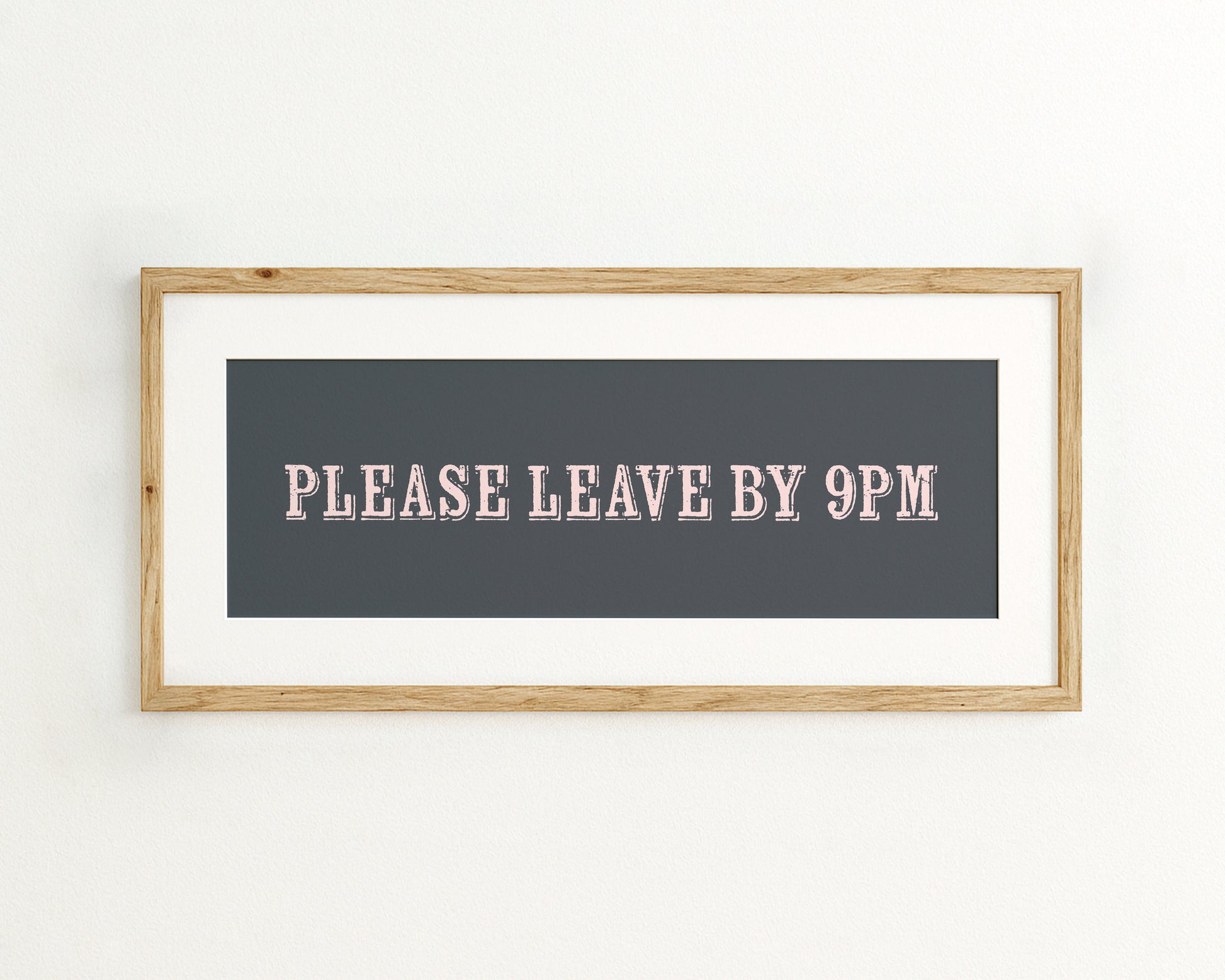 Framed sign with 'PLEASE LEAVE BY 9PM' text on a dark blue background