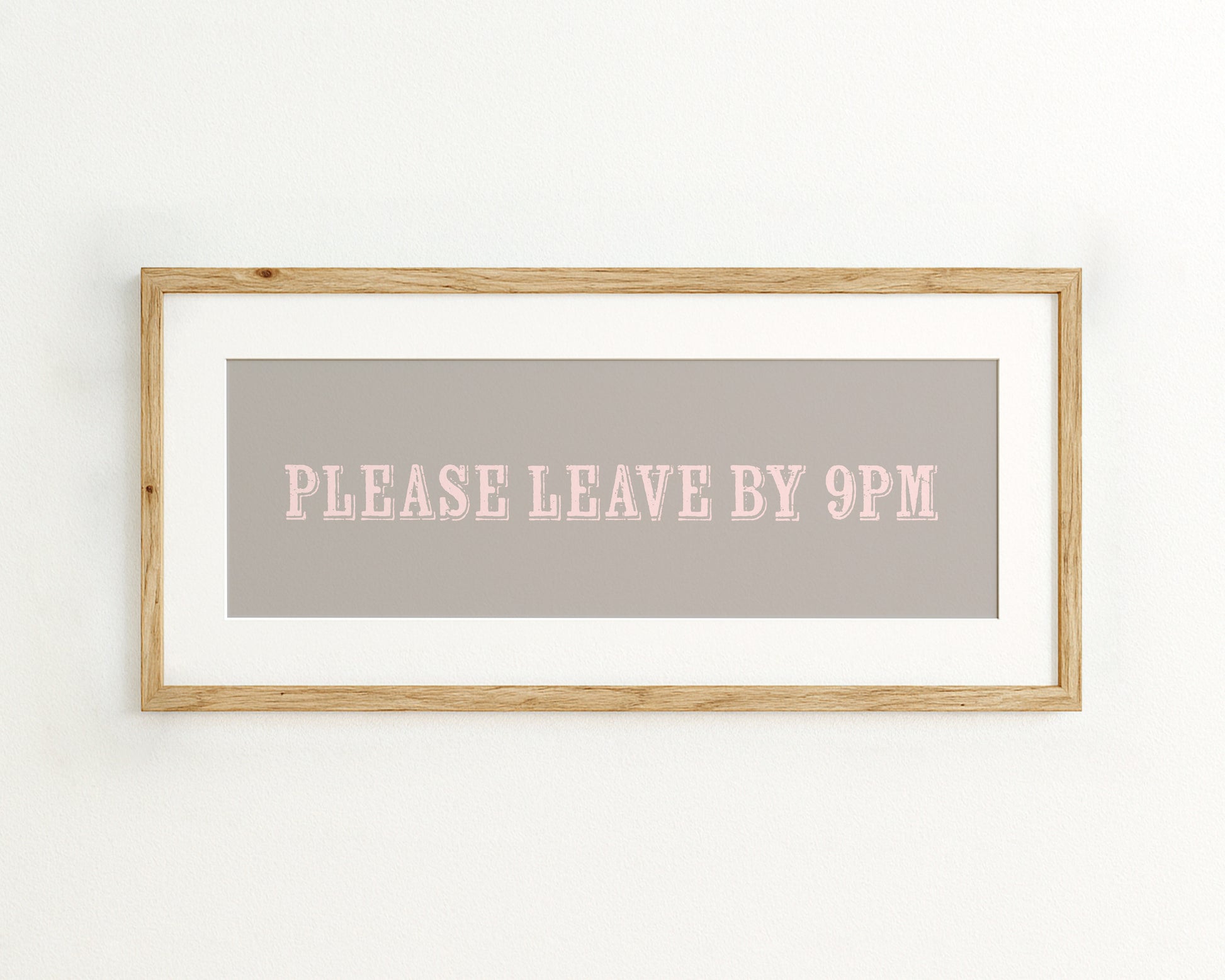 Framed sign with 'PLEASE LEAVE BY 9PM' text on a grey background