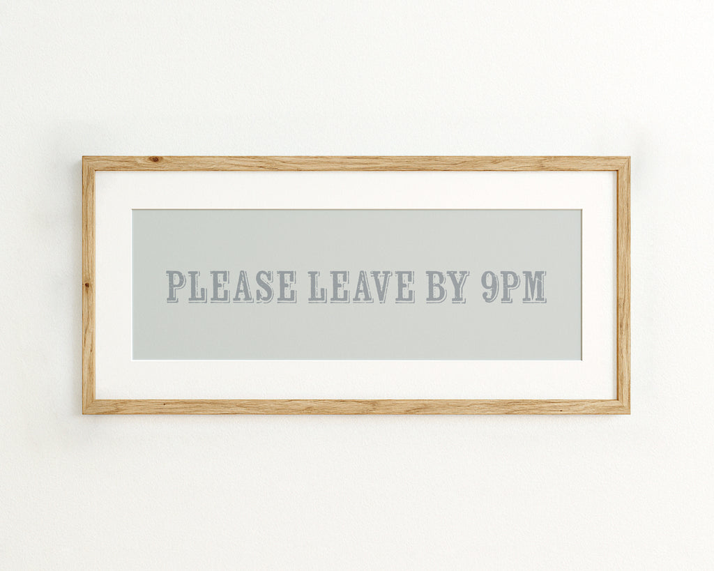 Framed artwork with text 'PLEASE LEAVE BY 9PM' on a light blue background