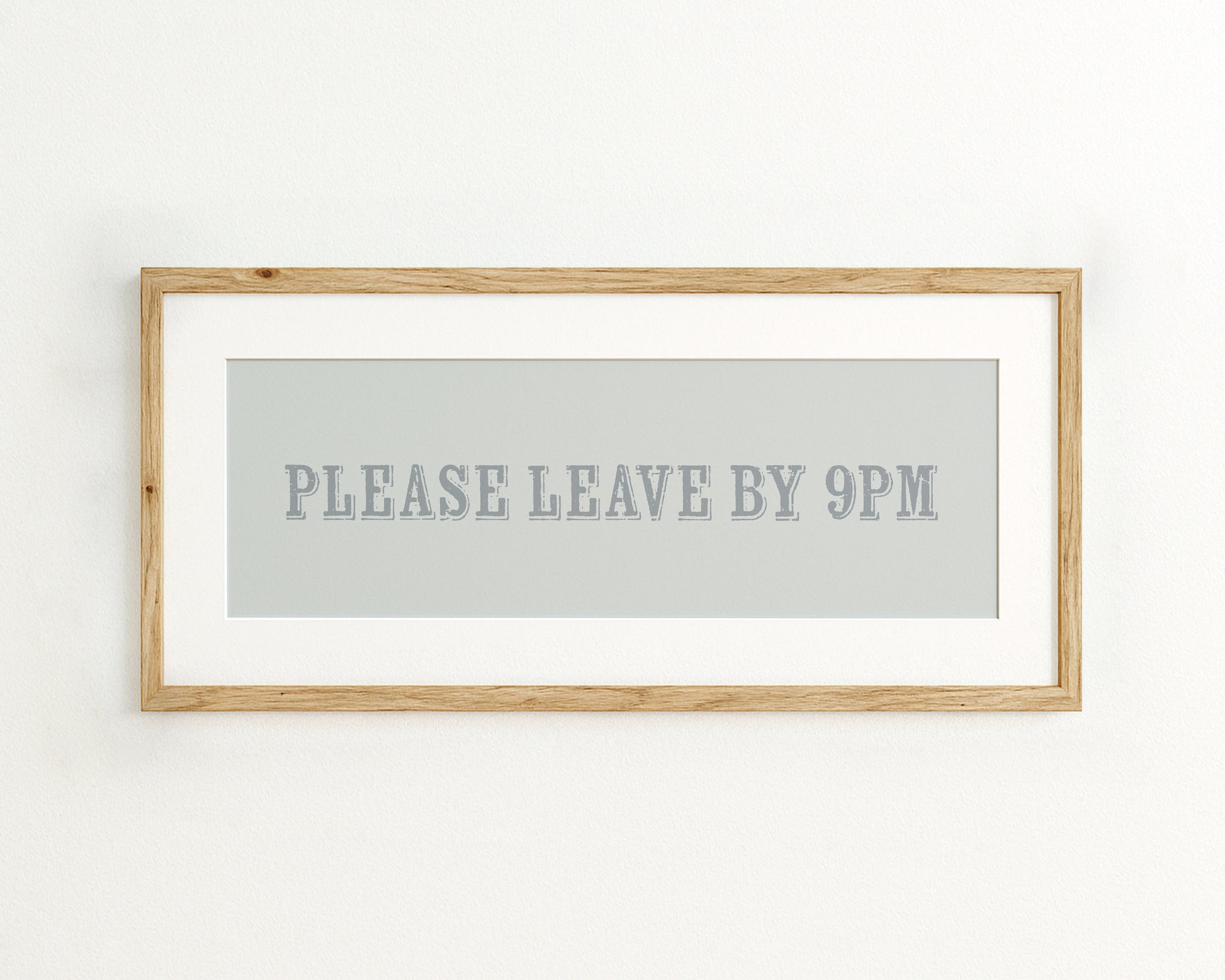 Framed artwork with text 'PLEASE LEAVE BY 9PM' on a light blue background