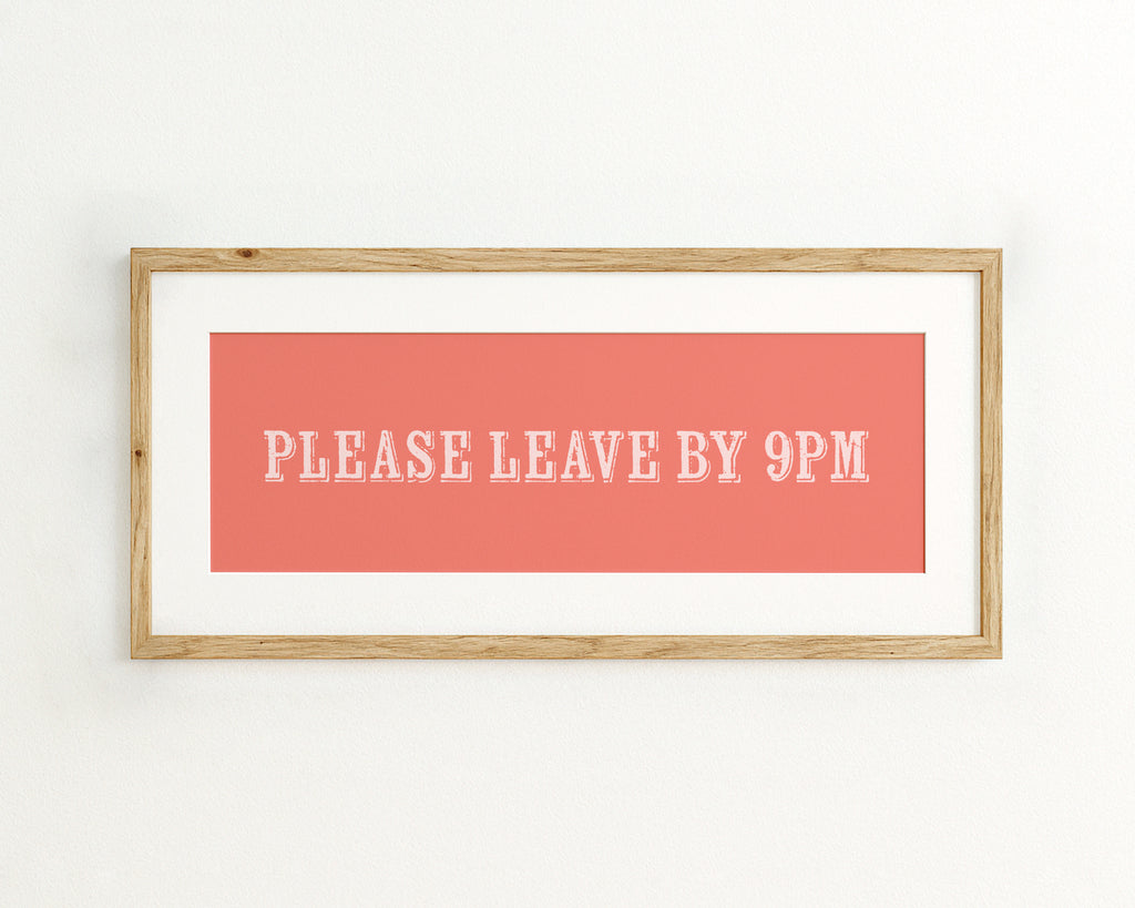 Framed poster with 'Please Leave By 9PM' text on a coral background