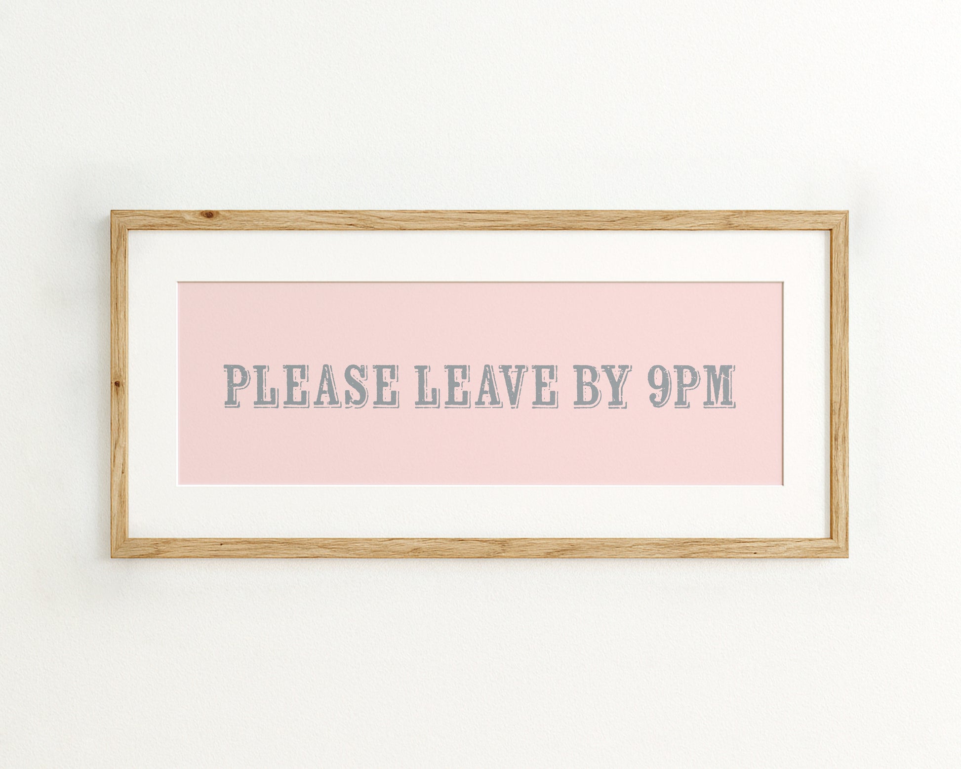 Framed sign with 'PLEASE LEAVE BY 9PM' text on a pink background