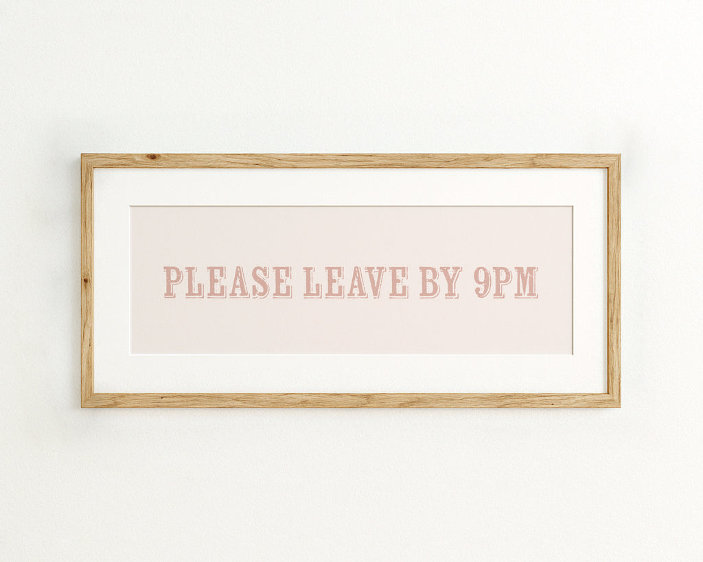 Framed artwork with text 'PLEASE LEAVE BY 9PM' on a light pinnk background