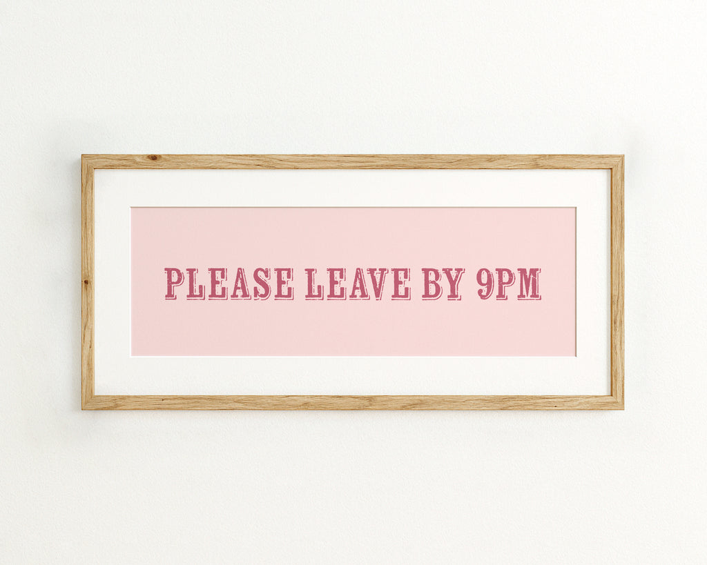 Framed sign with 'PLEASE LEAVE BY 9PM' text on a pink background