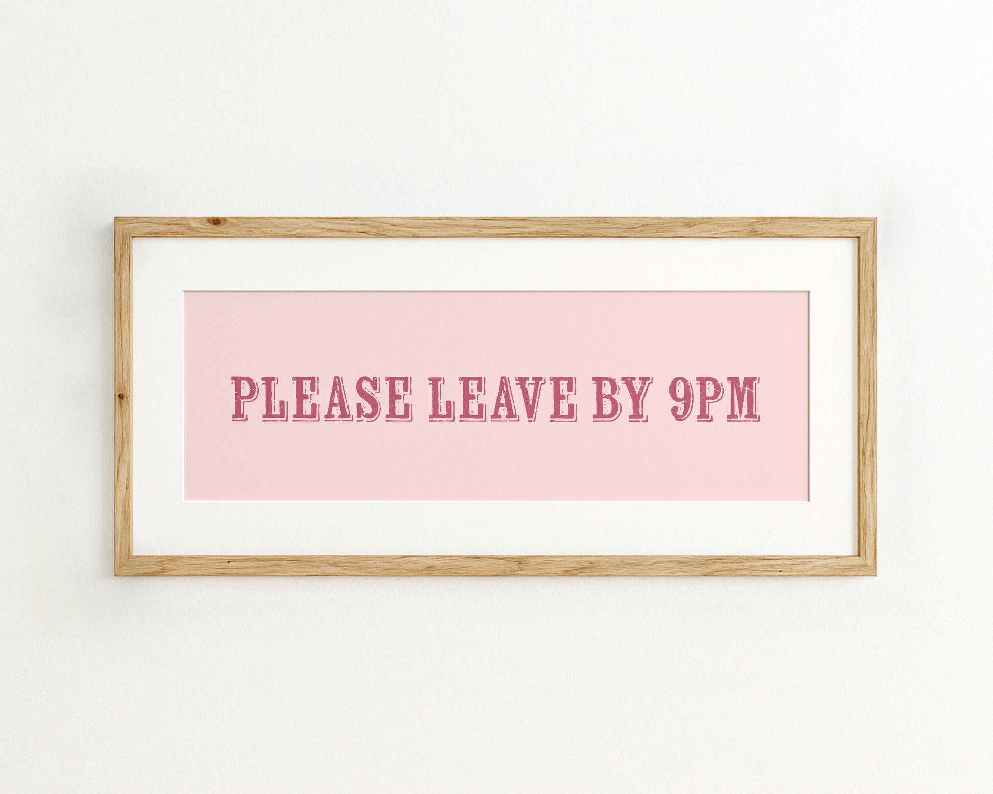 Framed sign with 'PLEASE LEAVE BY 9PM' text on a pink background