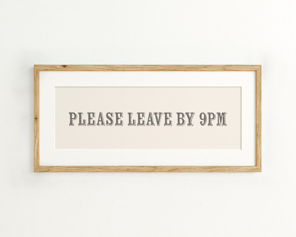 Framed sign with 'PLEASE LEAVE BY 9PM' text on a cream background