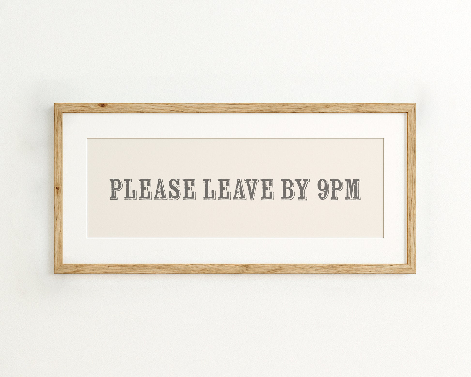 Framed sign with 'PLEASE LEAVE BY 9PM' text on a cream background