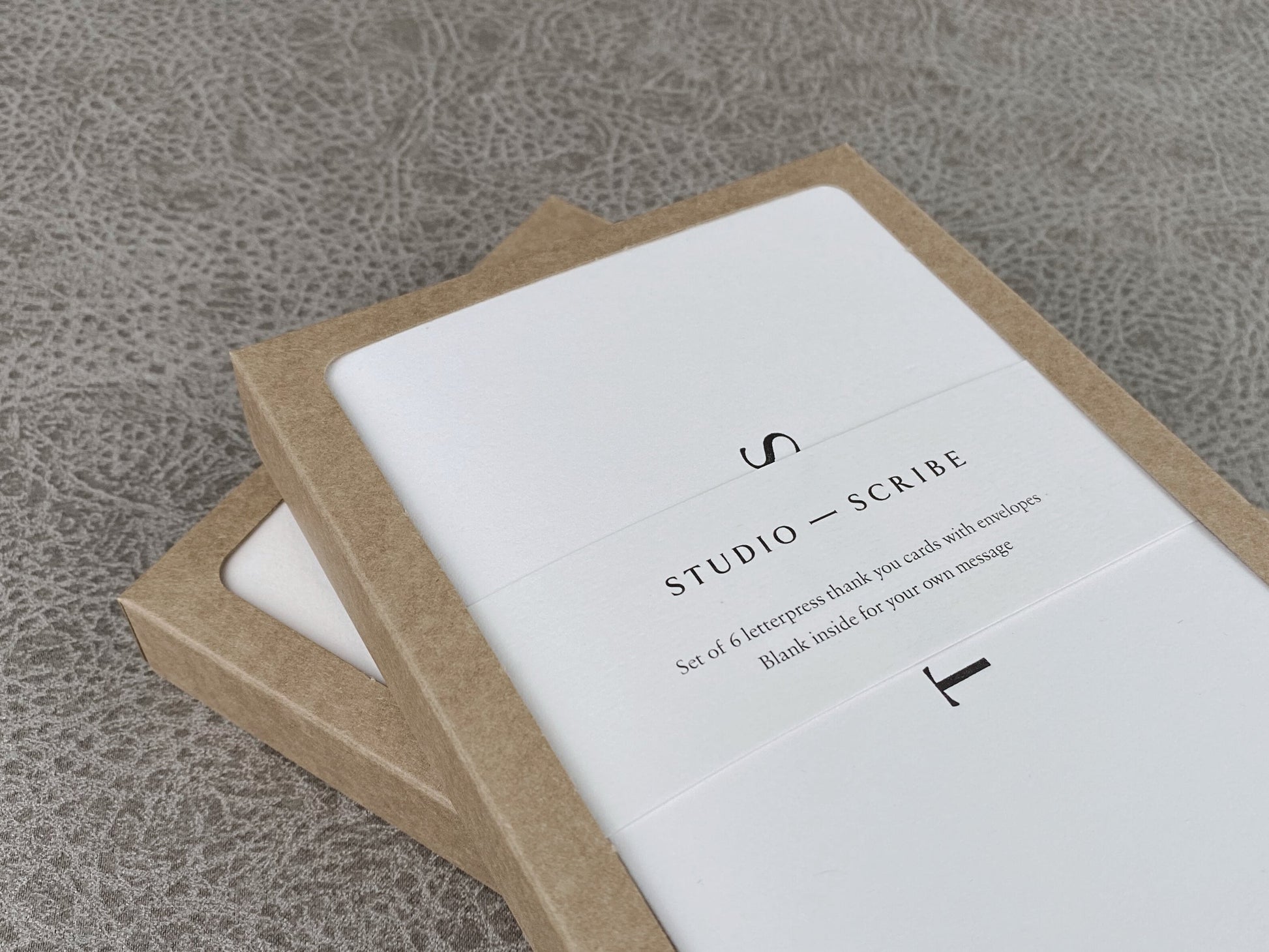 Greeting card packaging consisting of a kraft box with branded belly band