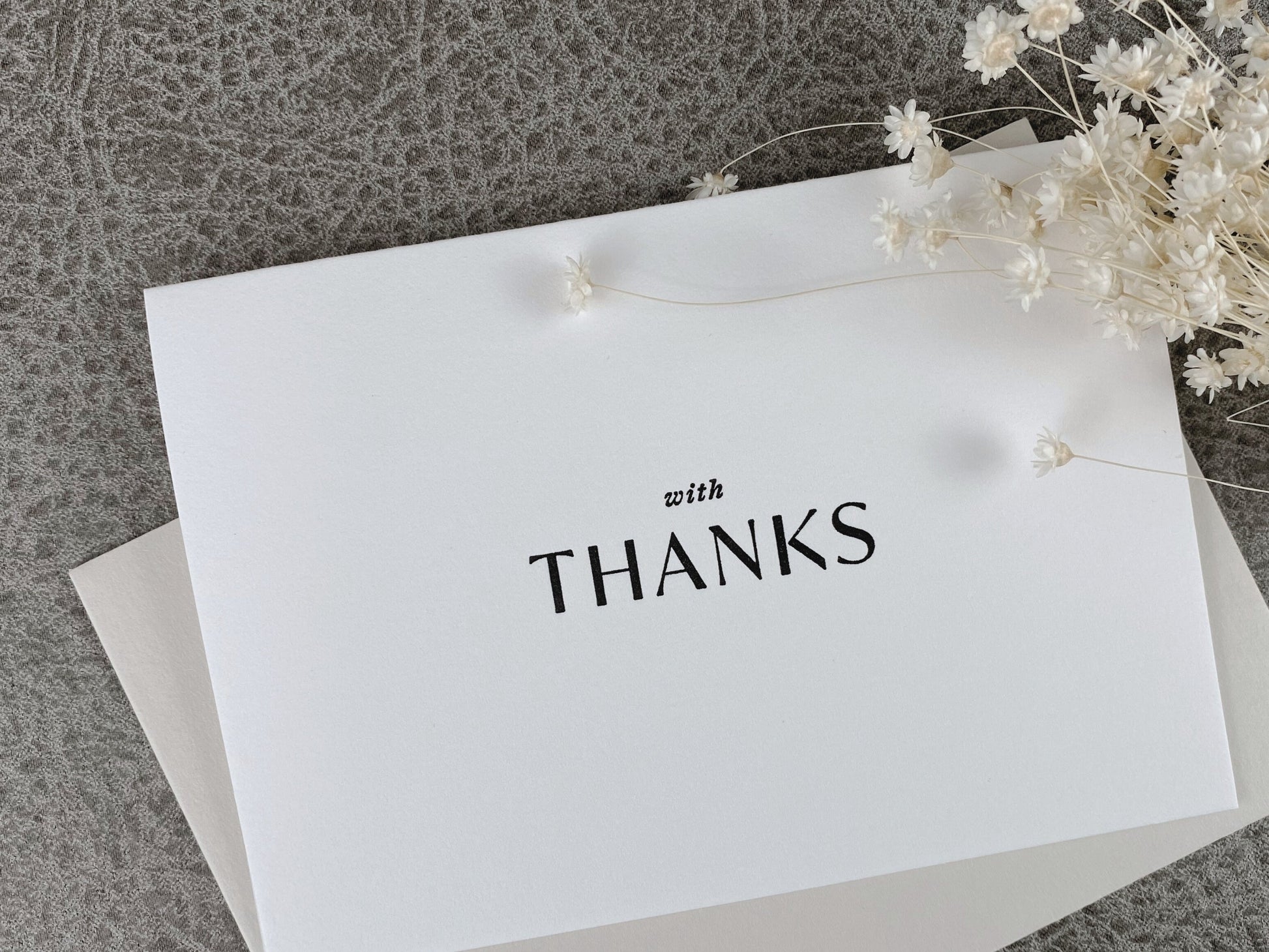 White 'with thanks' letterpress greeting card with blank ink and coordinating envelope