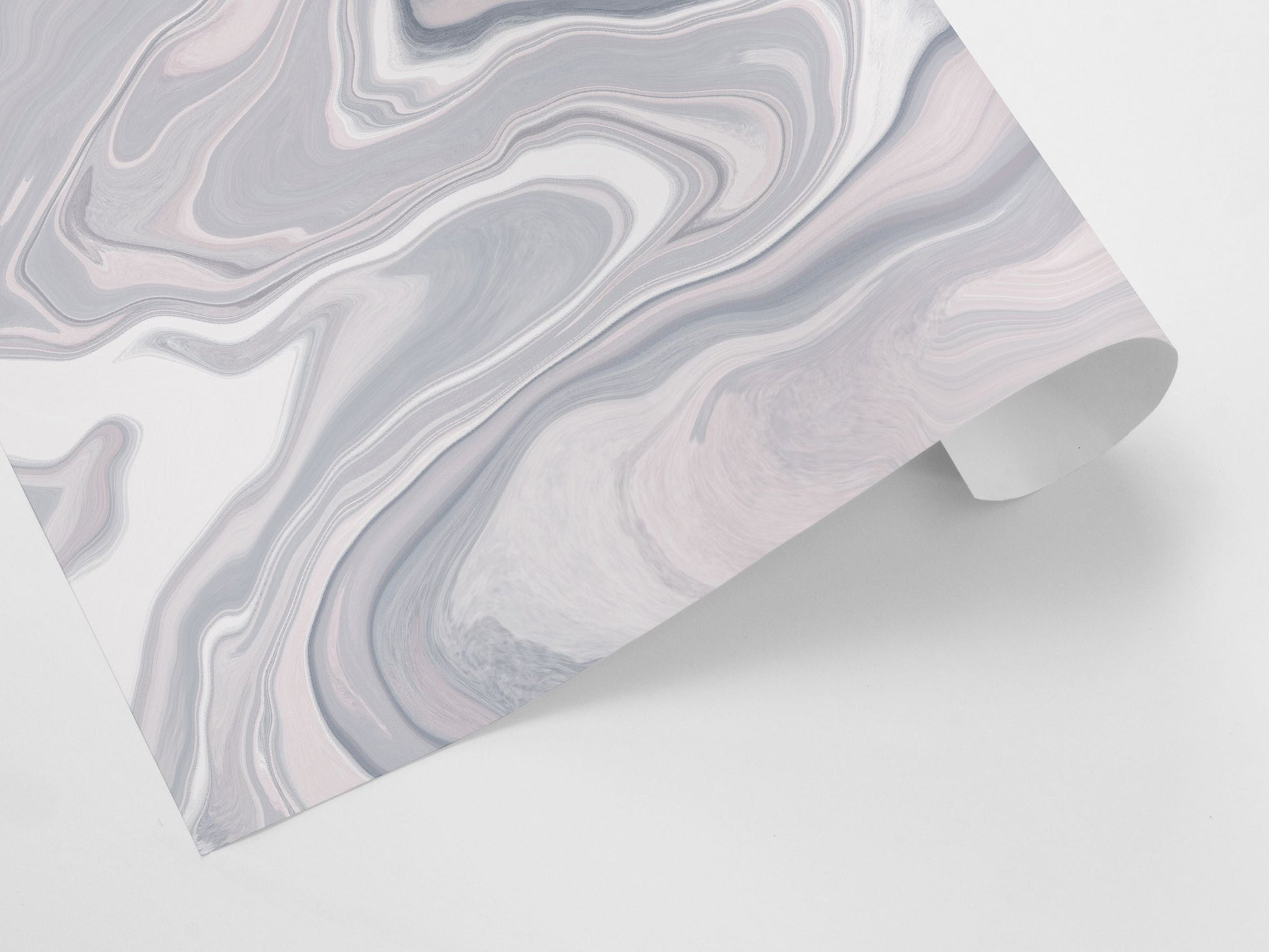 A rolled gift wrap sheet with an abstract marble pattern in pink and grey colors.