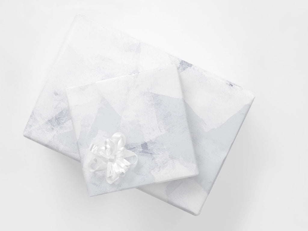 Gifts wrapped in a subtle abstract paper in blue and white tones