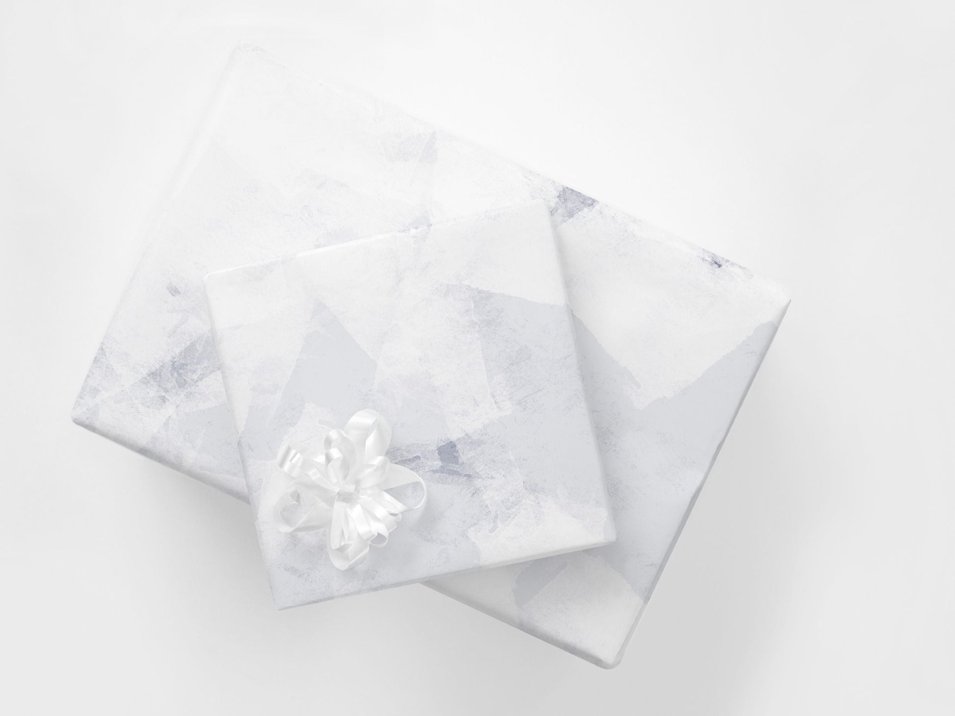 Gifts wrapped in a subtle abstract paper in blue and white tones