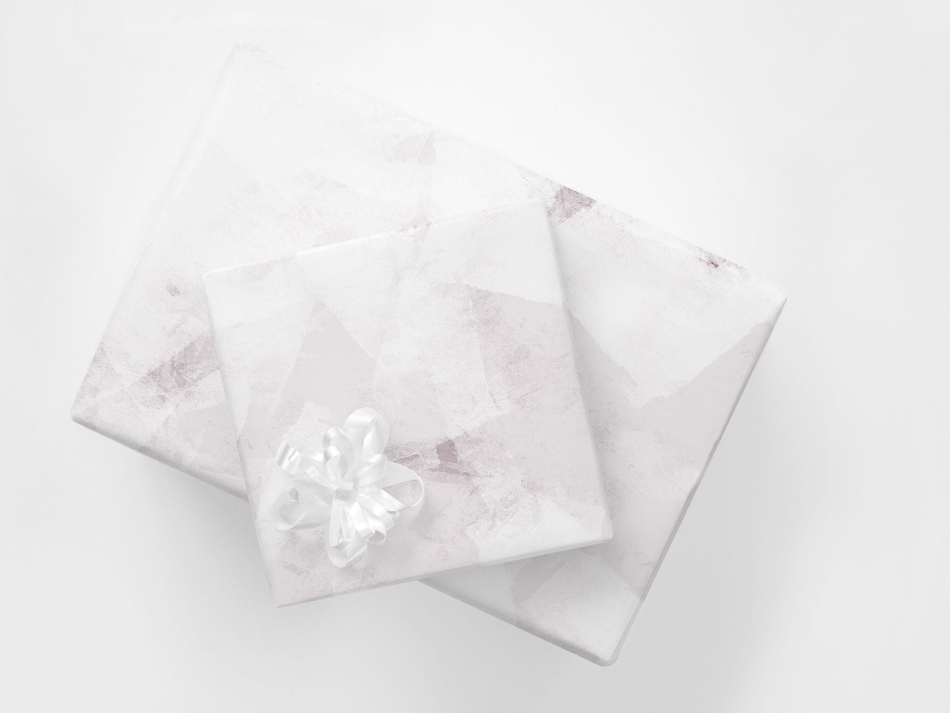 Stacked presents with soft pink abstract gift wrapping