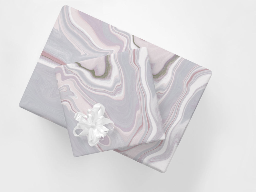 Stacked gifts wrapped in a contemporary wrapping paper featuring an abstract marble design