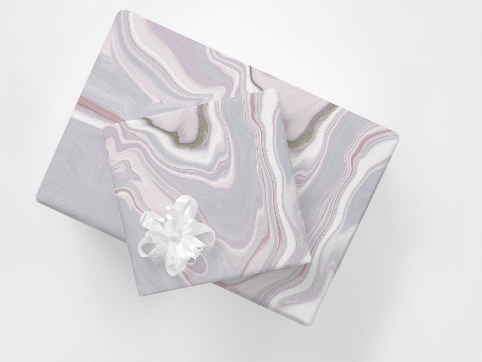 Stacked gifts wrapped in a contemporary wrapping paper featuring an abstract marble design