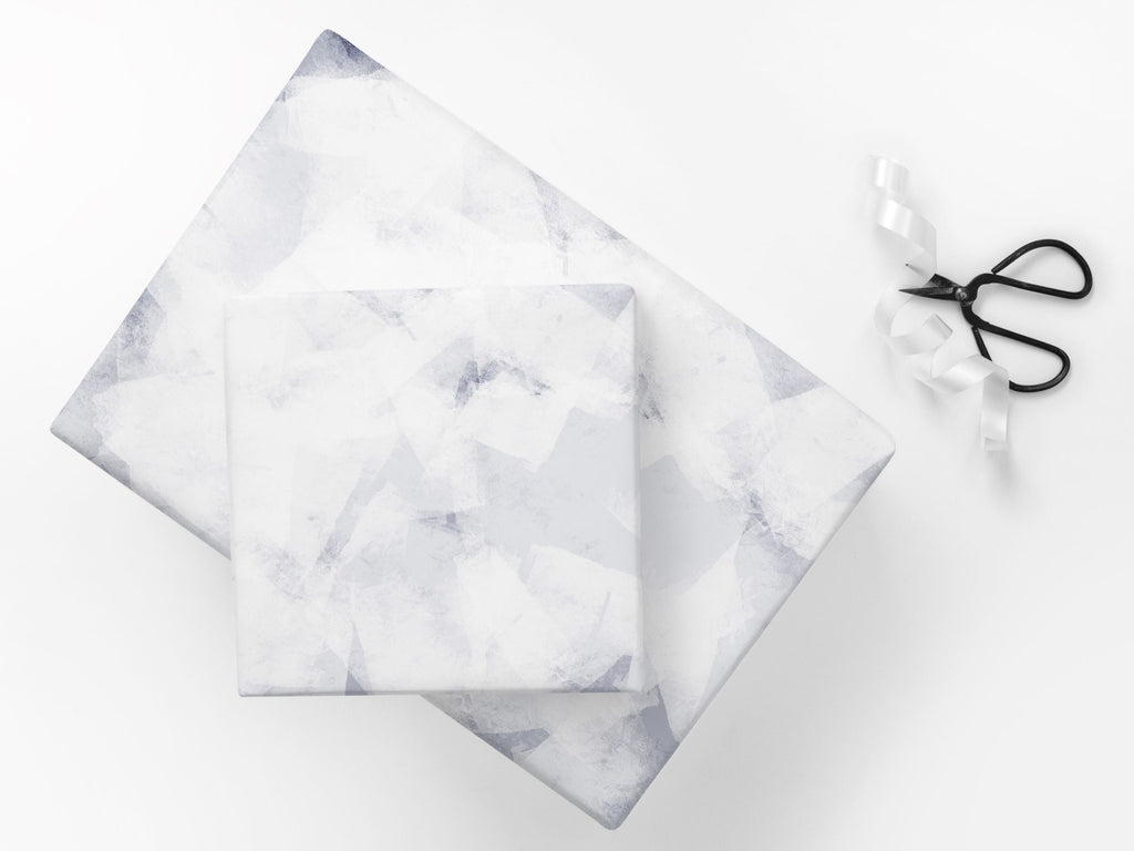 Gifts wrapped in a subtle abstract paper in blue and white tones