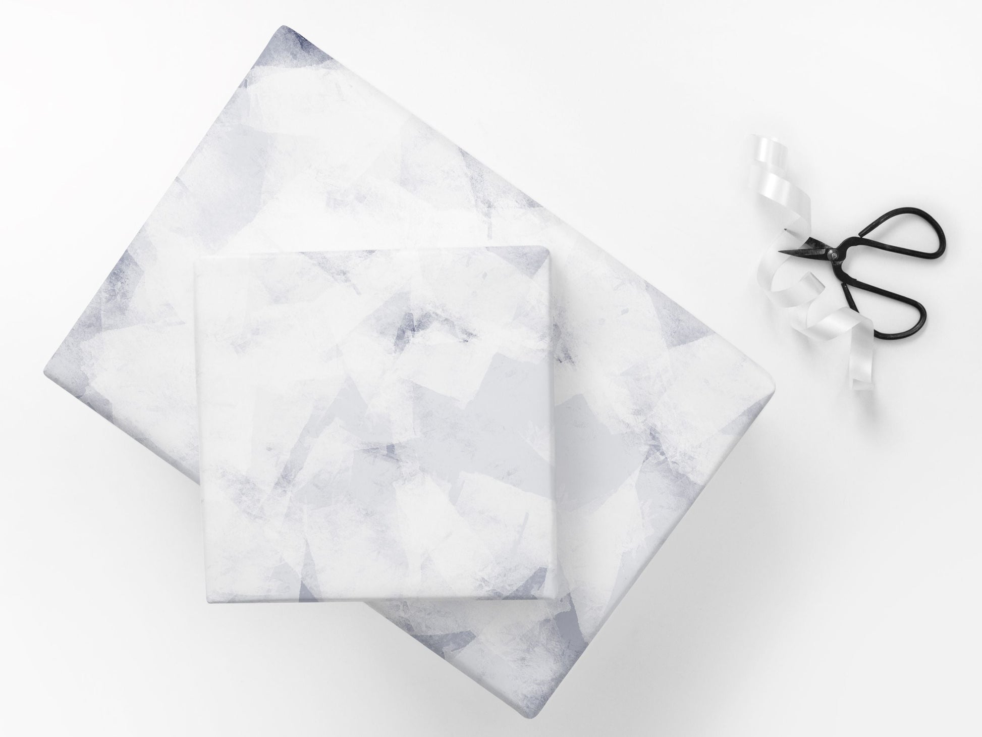 Gifts wrapped in a subtle abstract paper in blue and white tones